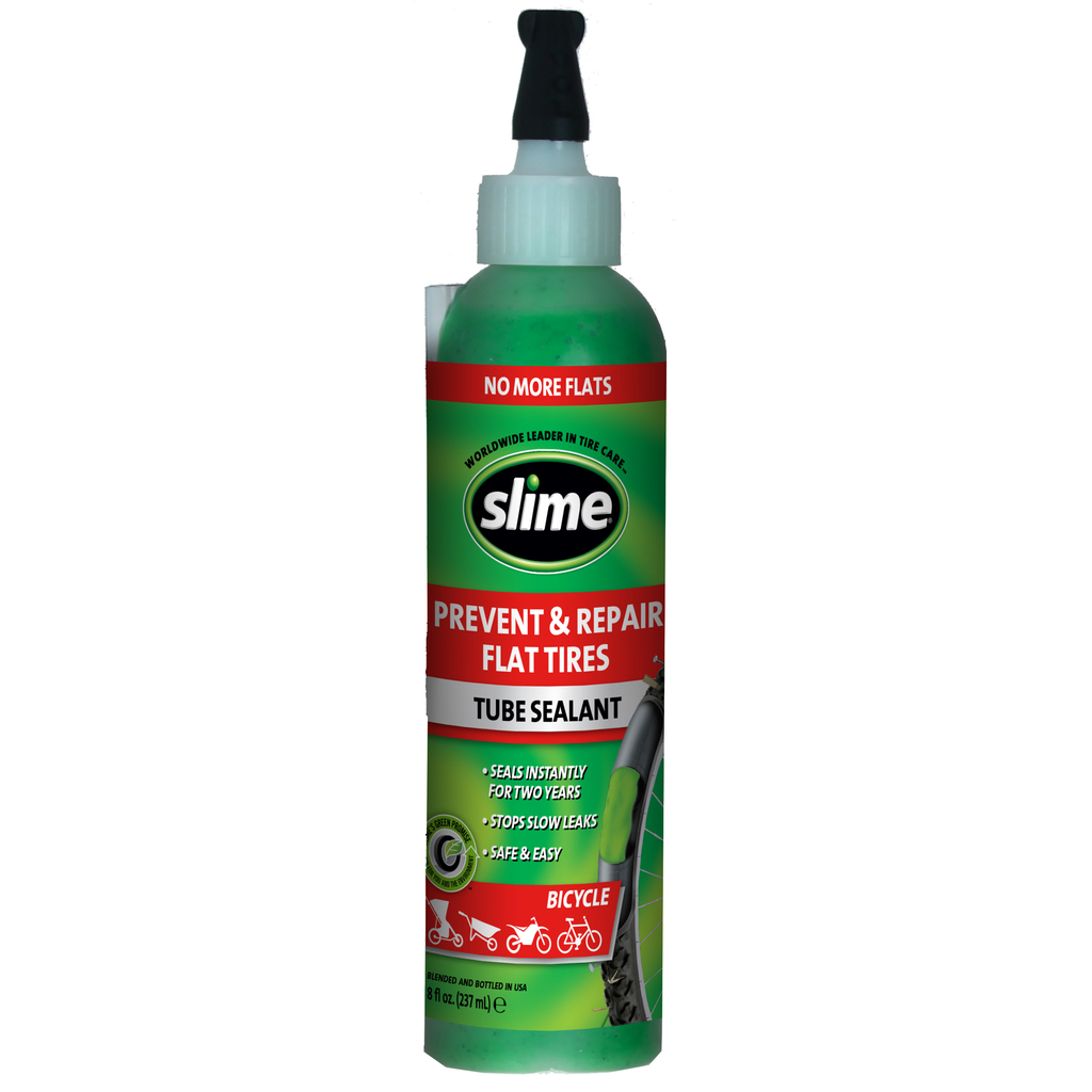 Zielona butelka Slime z uszczelniaczem do opon, z napisem "Prevent & Repair Flat Tires" na butelce.