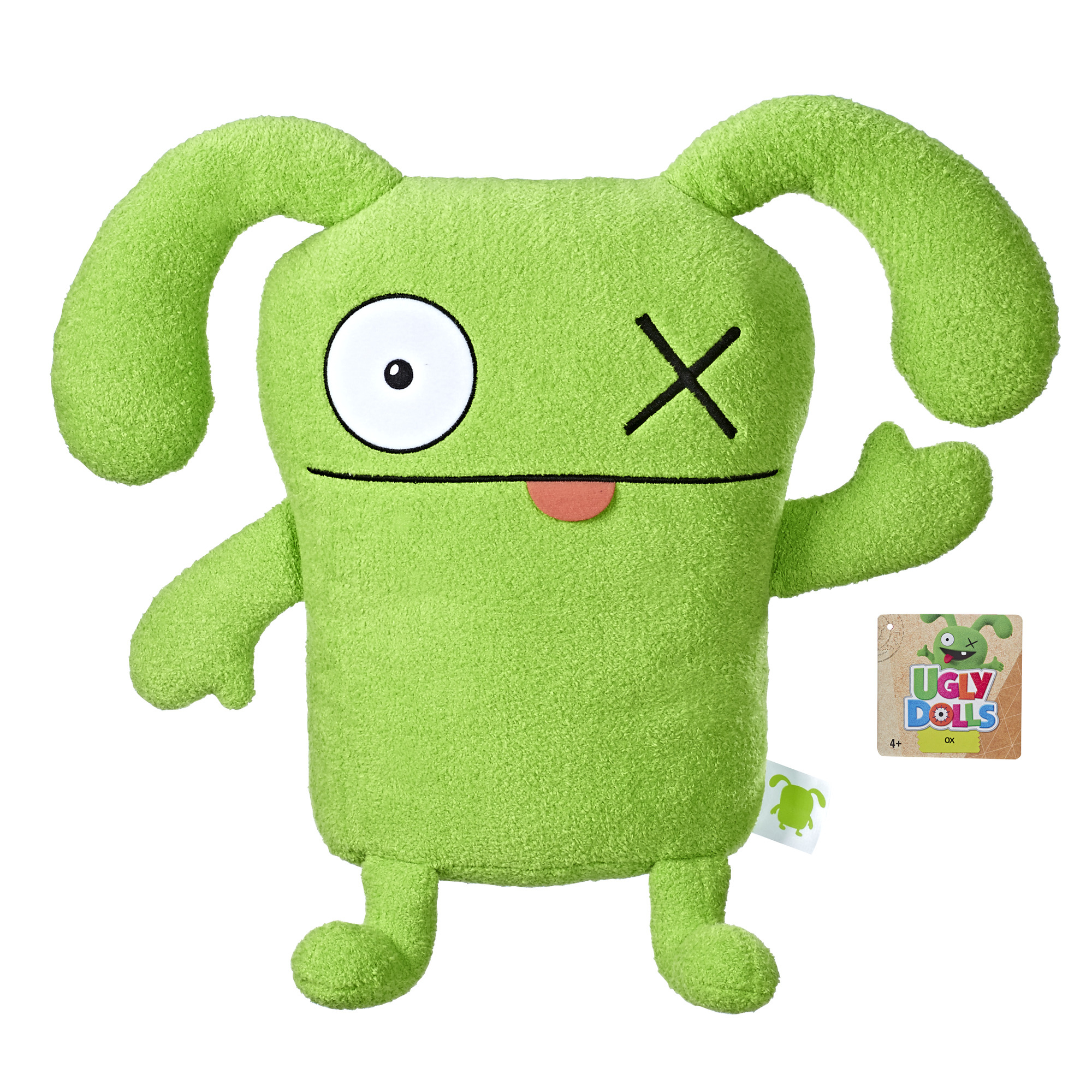 Zielona pluszowa zabawka z okiem, krzyżem i językiem. Etykieta Ugly Dolls. Białe tło.