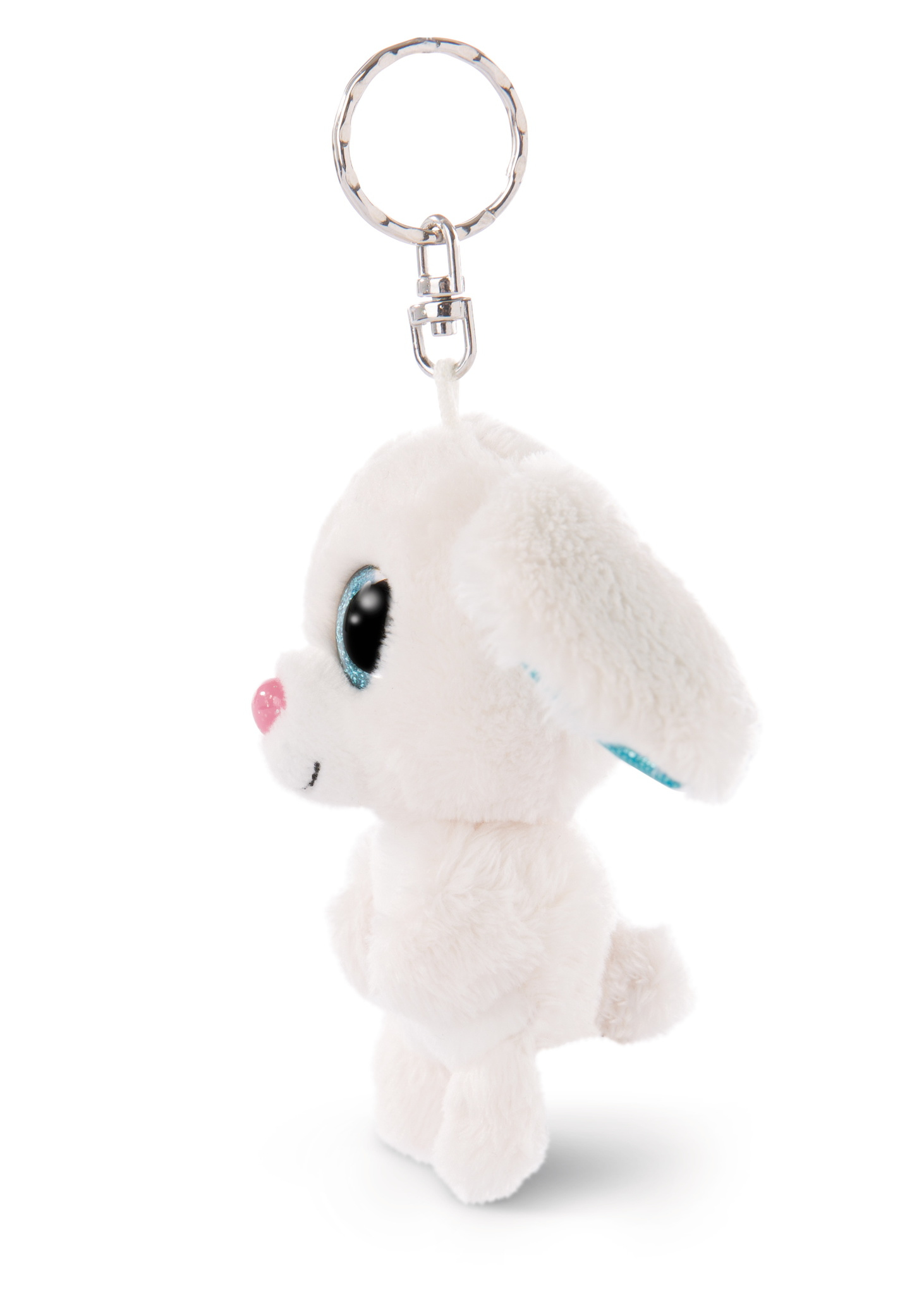 Biała pluszowa zabawka breloczek do kluczy z psem ze srebrnym kółkiem, stojąca na białej powierzchni.