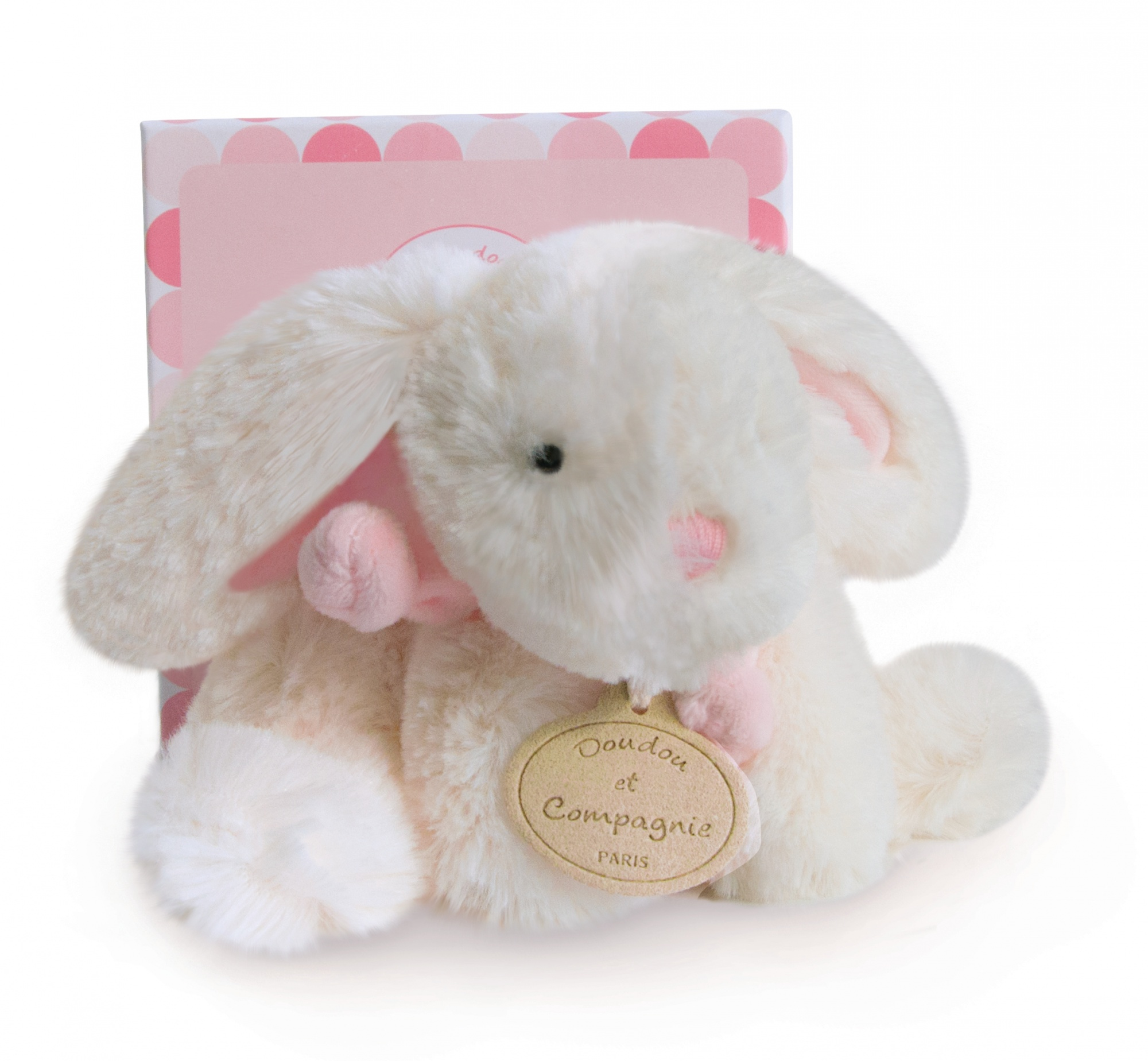 Biały pluszowy królik z różową wstążką i metką. Siedzi przed różowym pudełkiem.