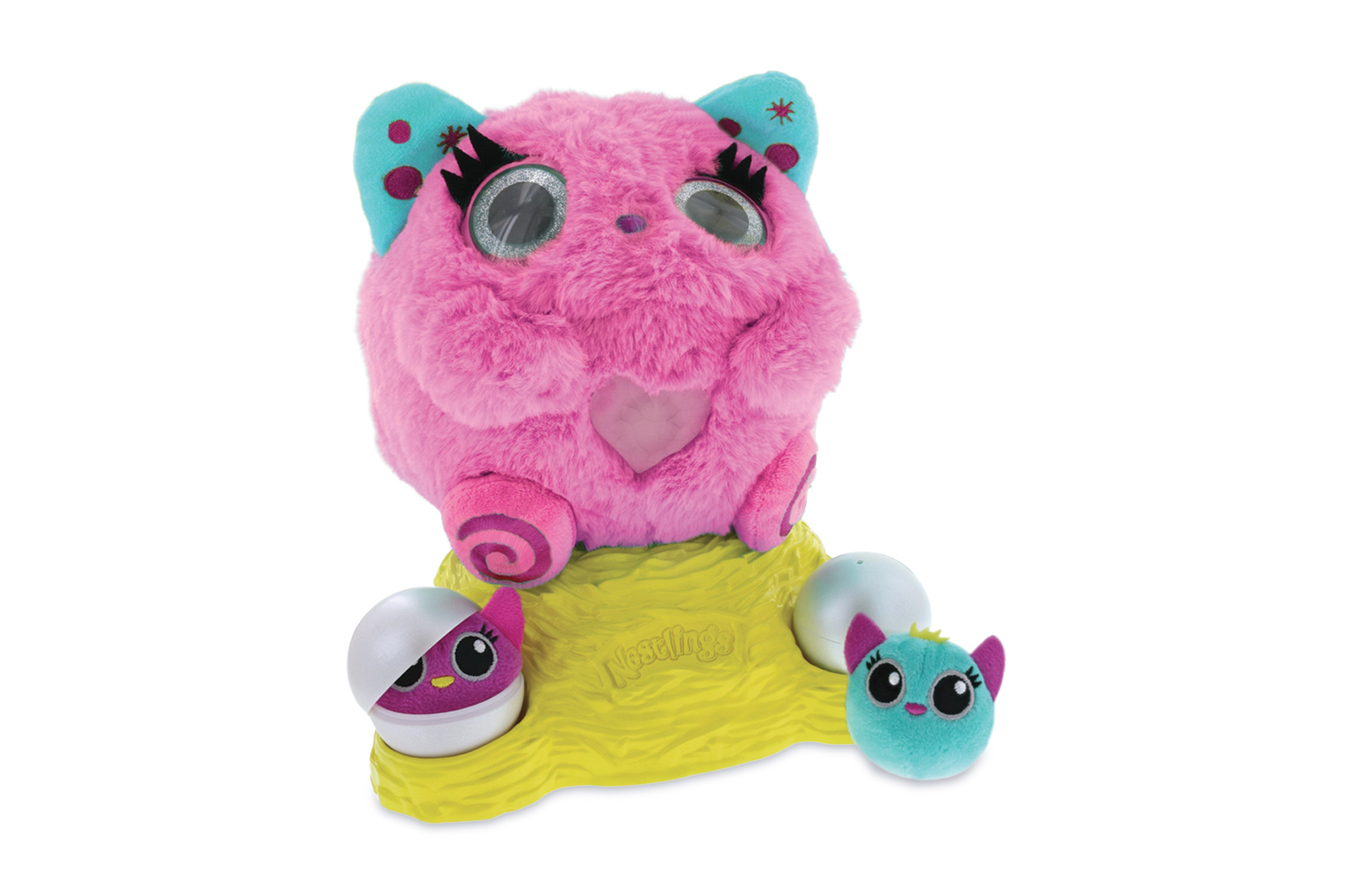 Peluche rosa con base gialla, due piccoli giocattoli a forma di uovo e altri due giocattoli.