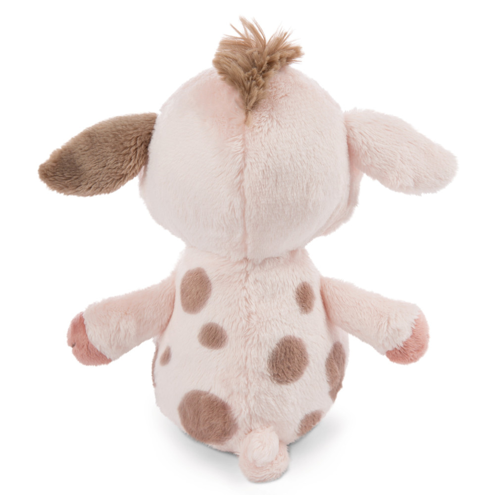 Un peluche rosa a forma di mucca con macchie marroni, visto da dietro.