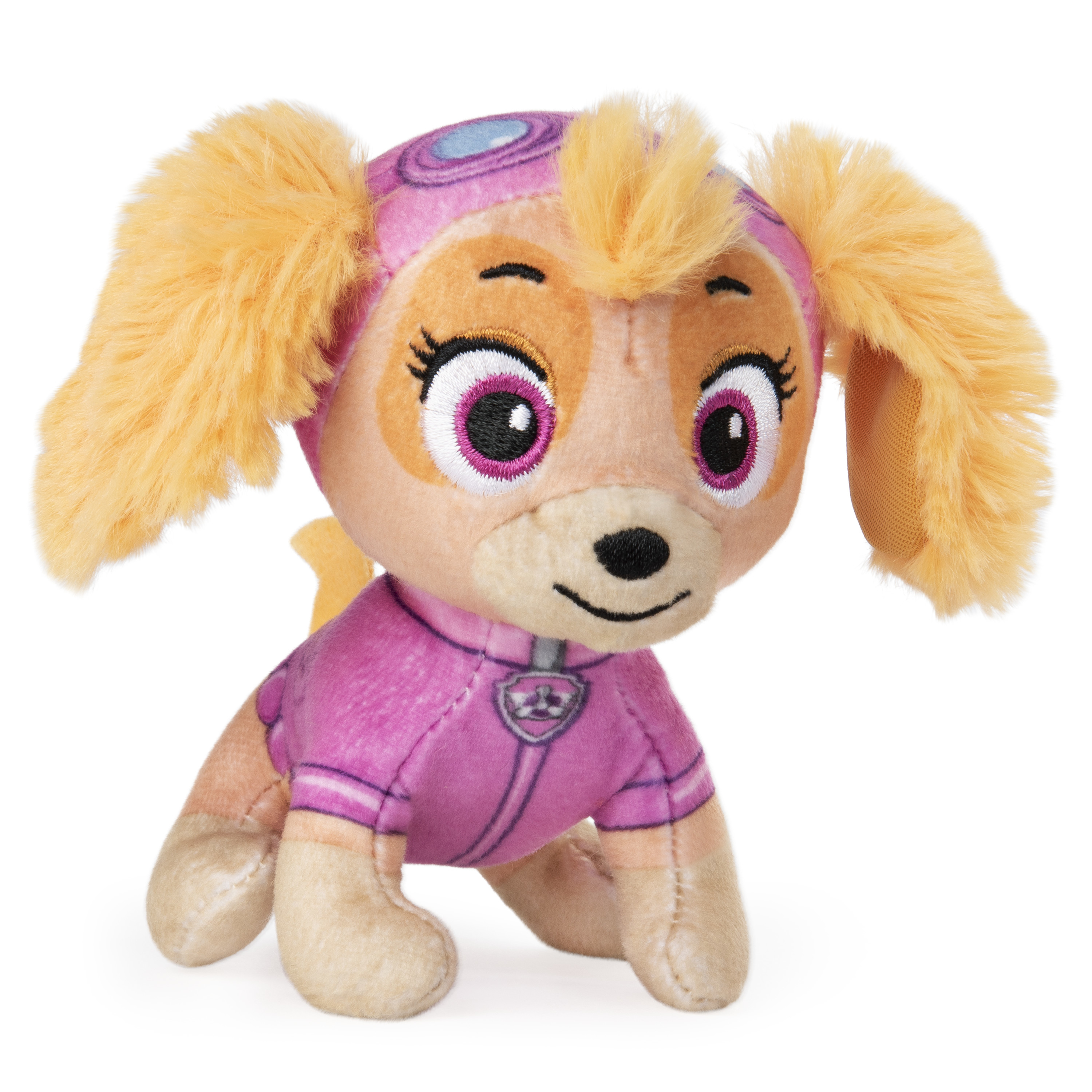 Un peluche de Skye de Paw Patrol, con uniforme rosa y casco rosa y azul.