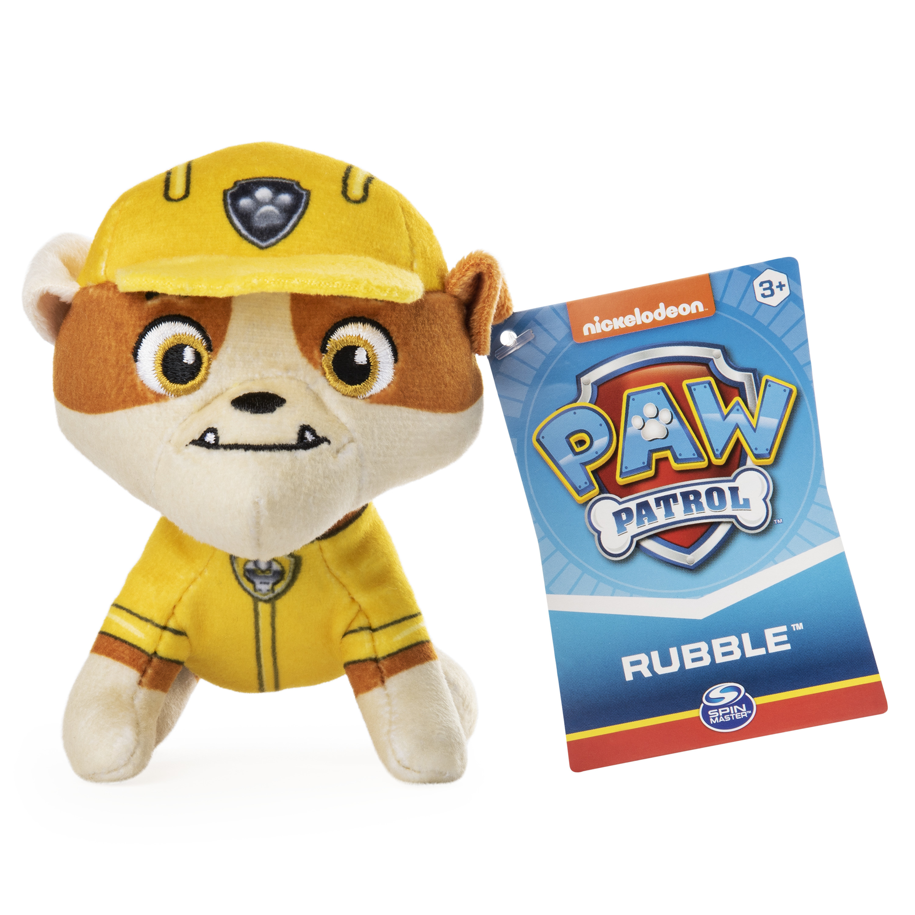 Peluche Rubble de Paw Patrol con gorro y uniforme amarillo. Tiene una etiqueta que dice Paw Patrol.