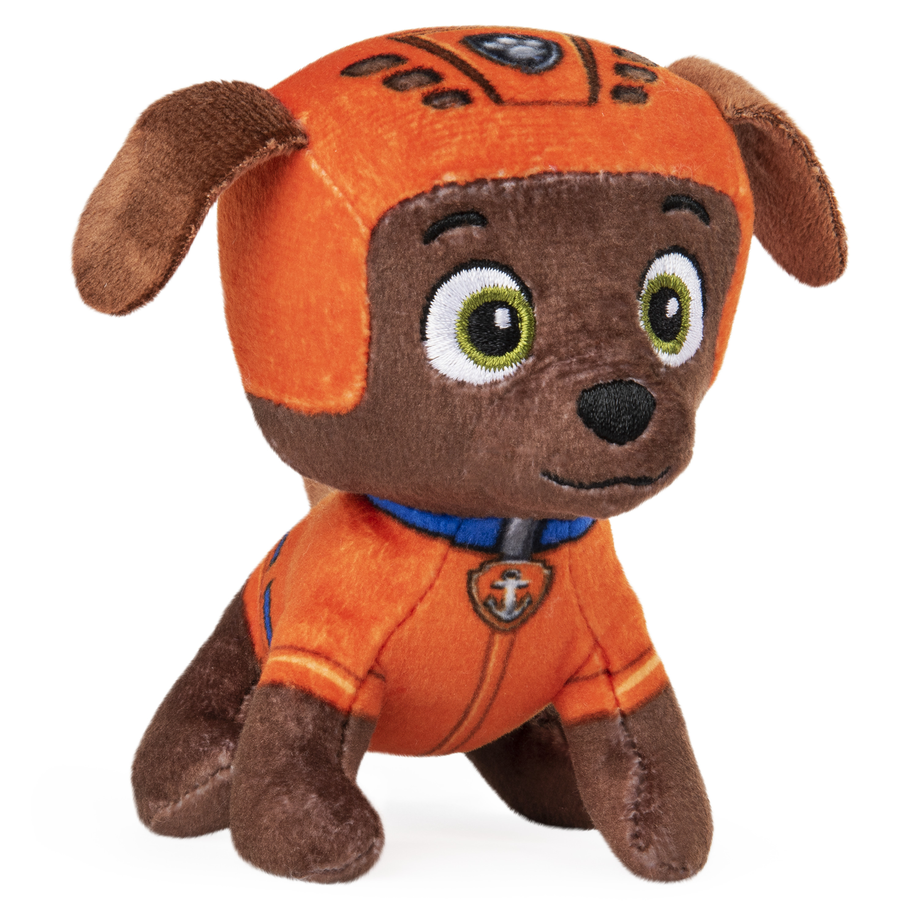 Un peluche de Zuma de Paw Patrol, con uniforme y casco naranja. Está sentado.