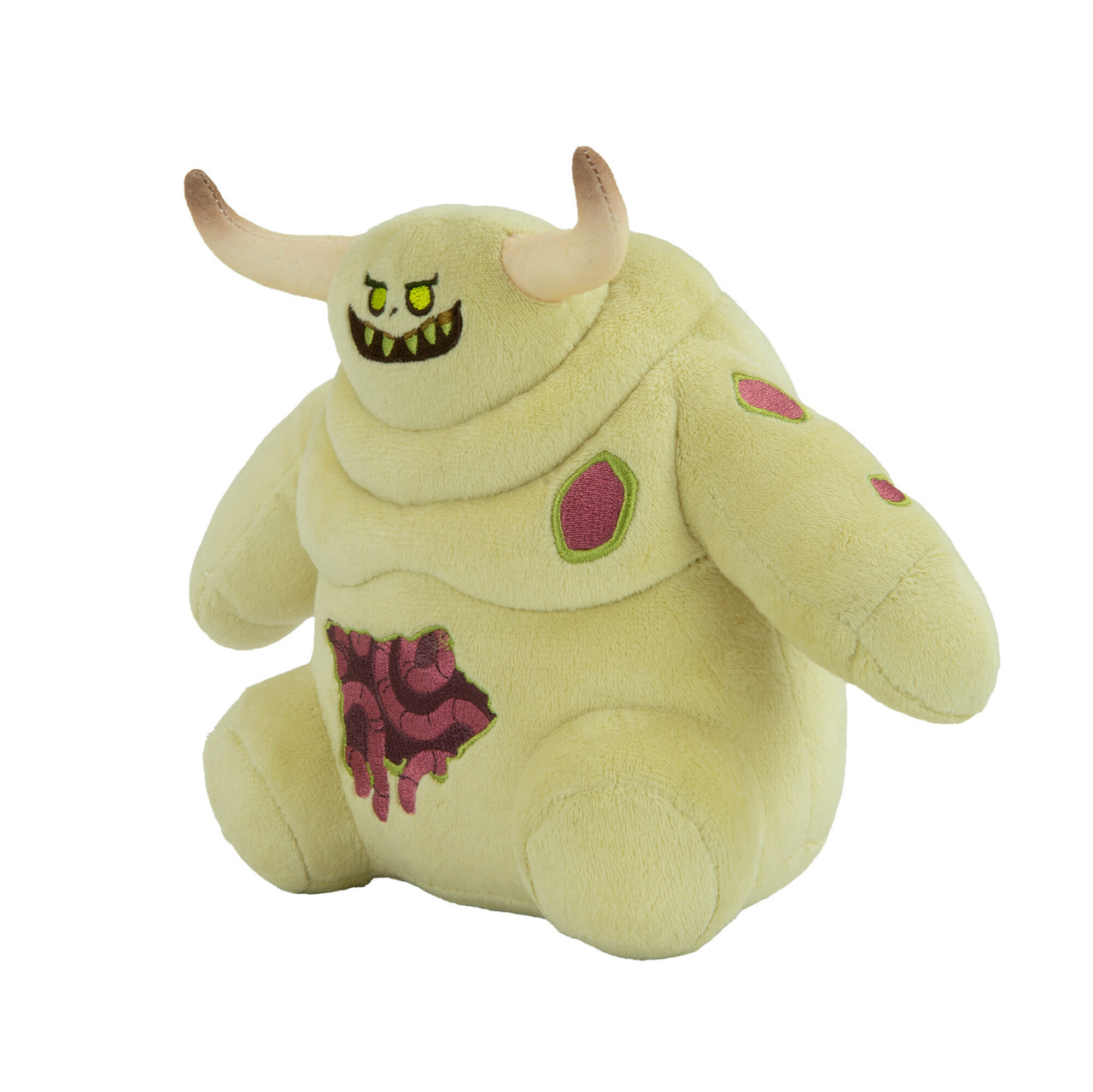 Un jouet en peluche jaune avec un design de monstre. Il a des cornes, une bouche et des taches roses sur le corps.