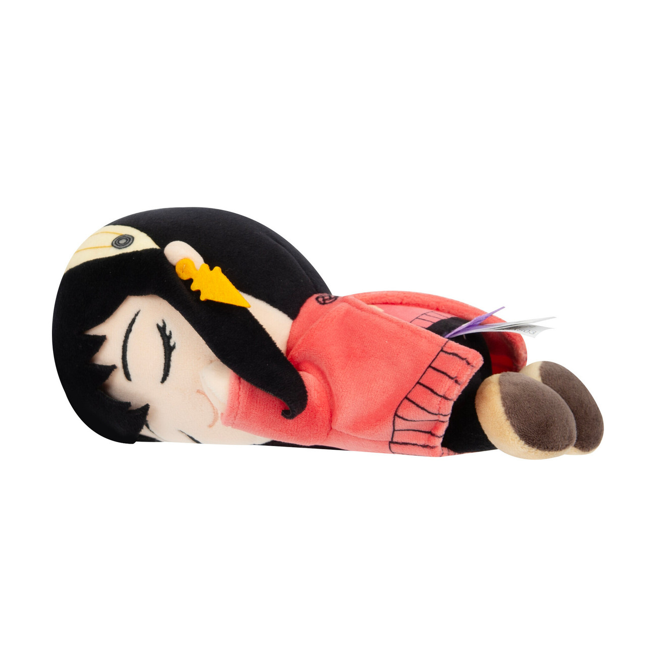 Peluche di una bambina sdraiata, con un maglione rosso, capelli neri e un incarnato chiaro.