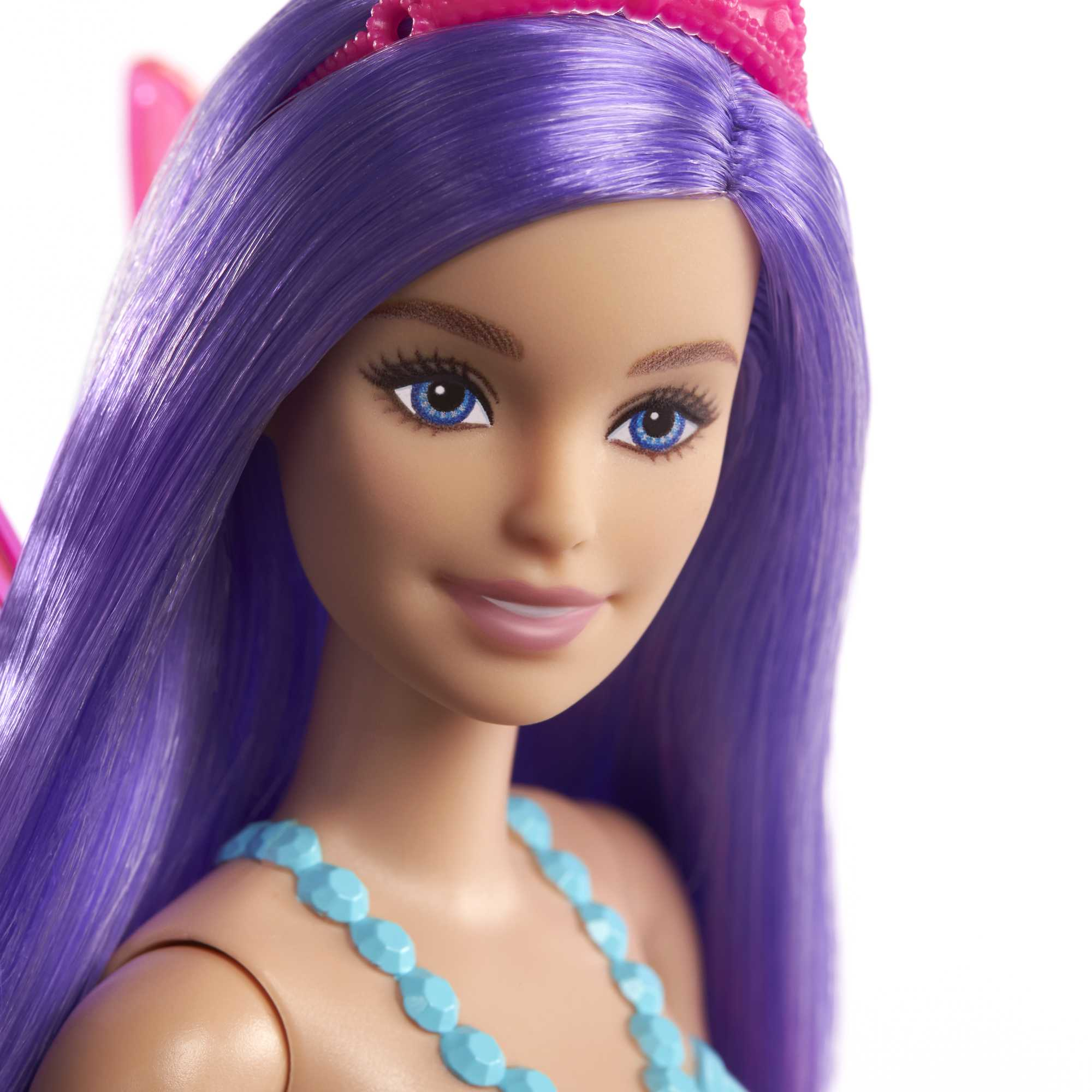 Nahaufnahme des Gesichts einer Barbie-Puppe mit lila Haaren, blauen Augen und einer Tiara.