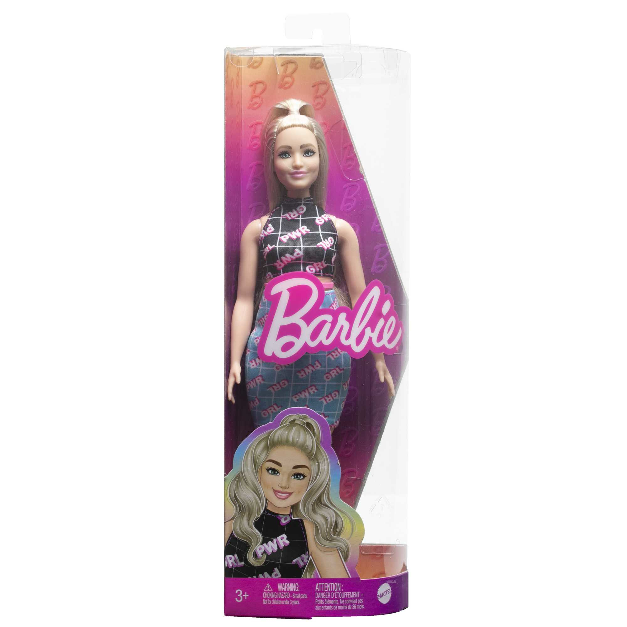Barbie-Puppe in einer durchsichtigen Box. Sie trägt ein schwarz-weiß gemustertes Oberteil und Jeans.