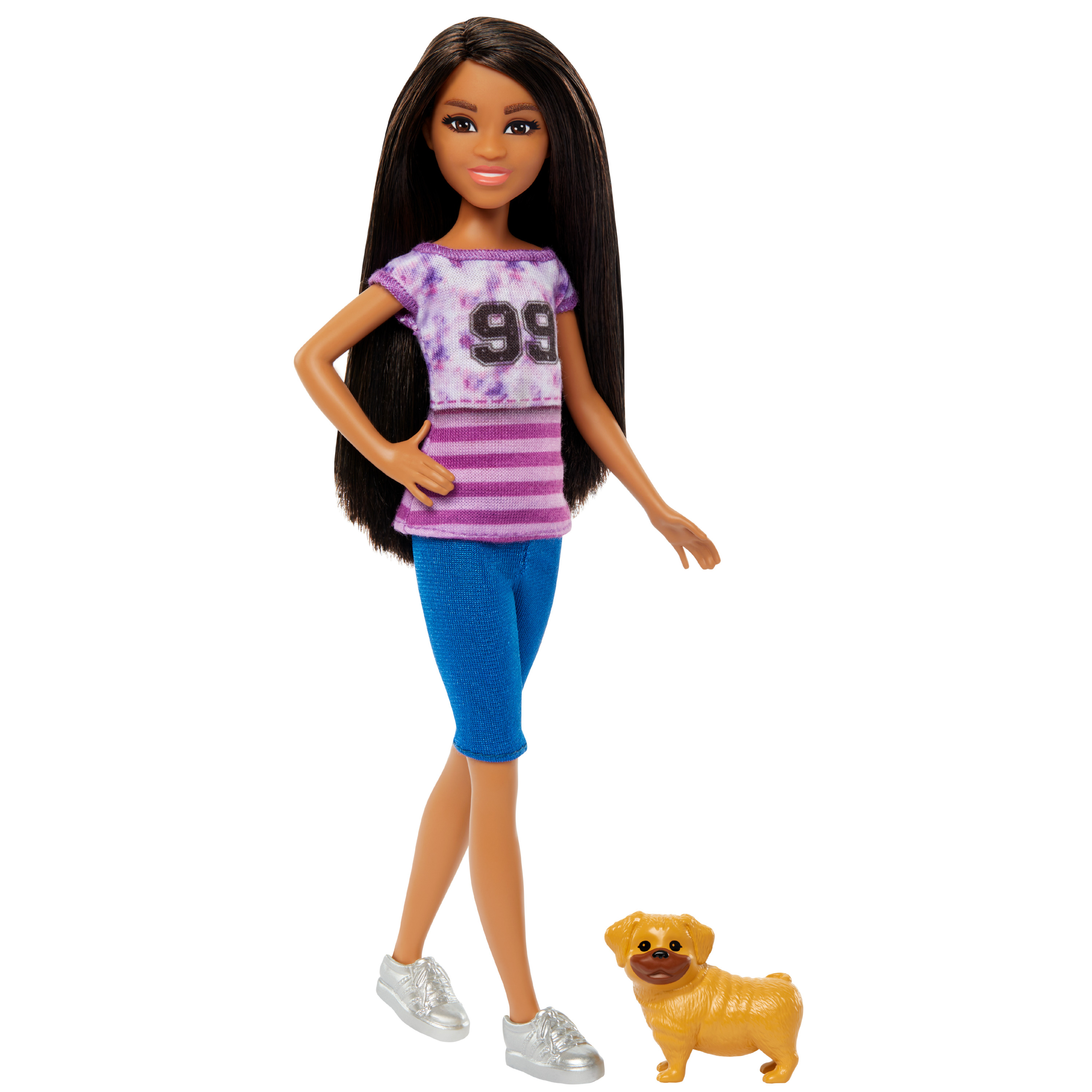 Eine Barbie-Puppe steht mit einem Hund, trägt blaue Shorts und ein lila Oberteil mit der Nummer 99.