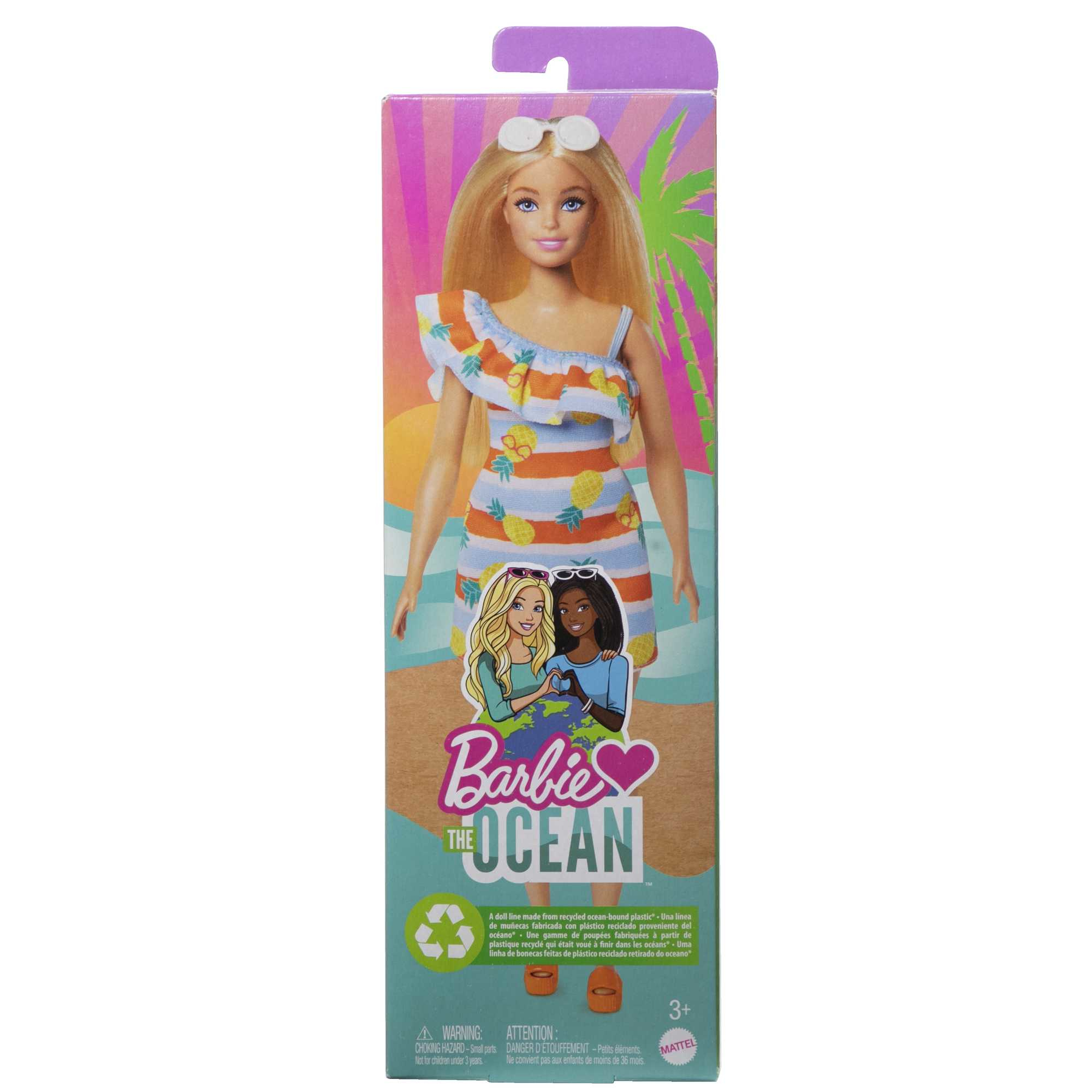 Pudełko lalki Barbie The Ocean. Barbie ma na sobie sukienkę, okulary przeciwsłoneczne są na górze, a w tle scena na plaży.