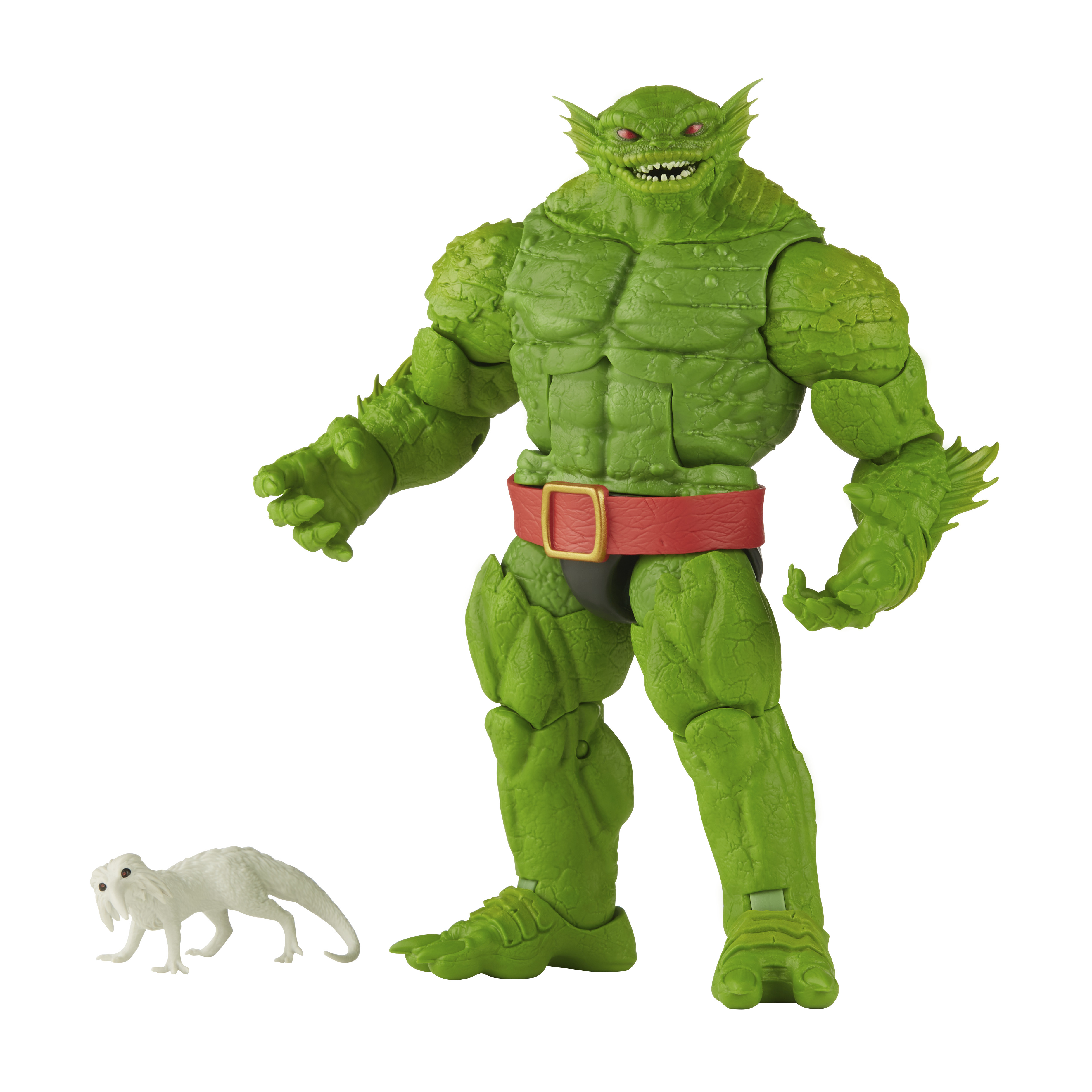 Zielona figurka potwora z czerwonym pasem, małe białe stworzenie u stóp.