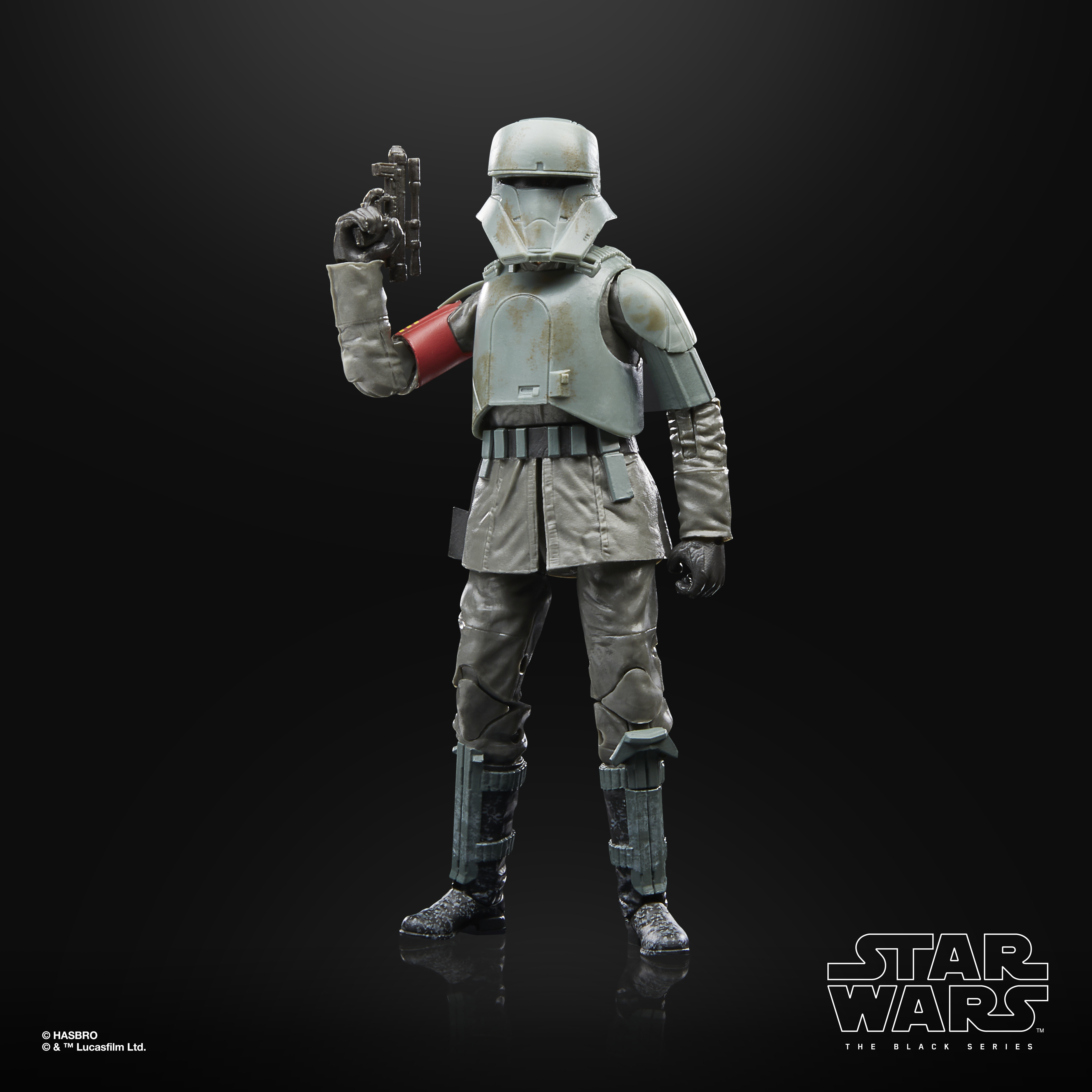 Figura di Star Wars di un soldato in uniforme grigia, elmetto e che tiene una pistola, su sfondo scuro.