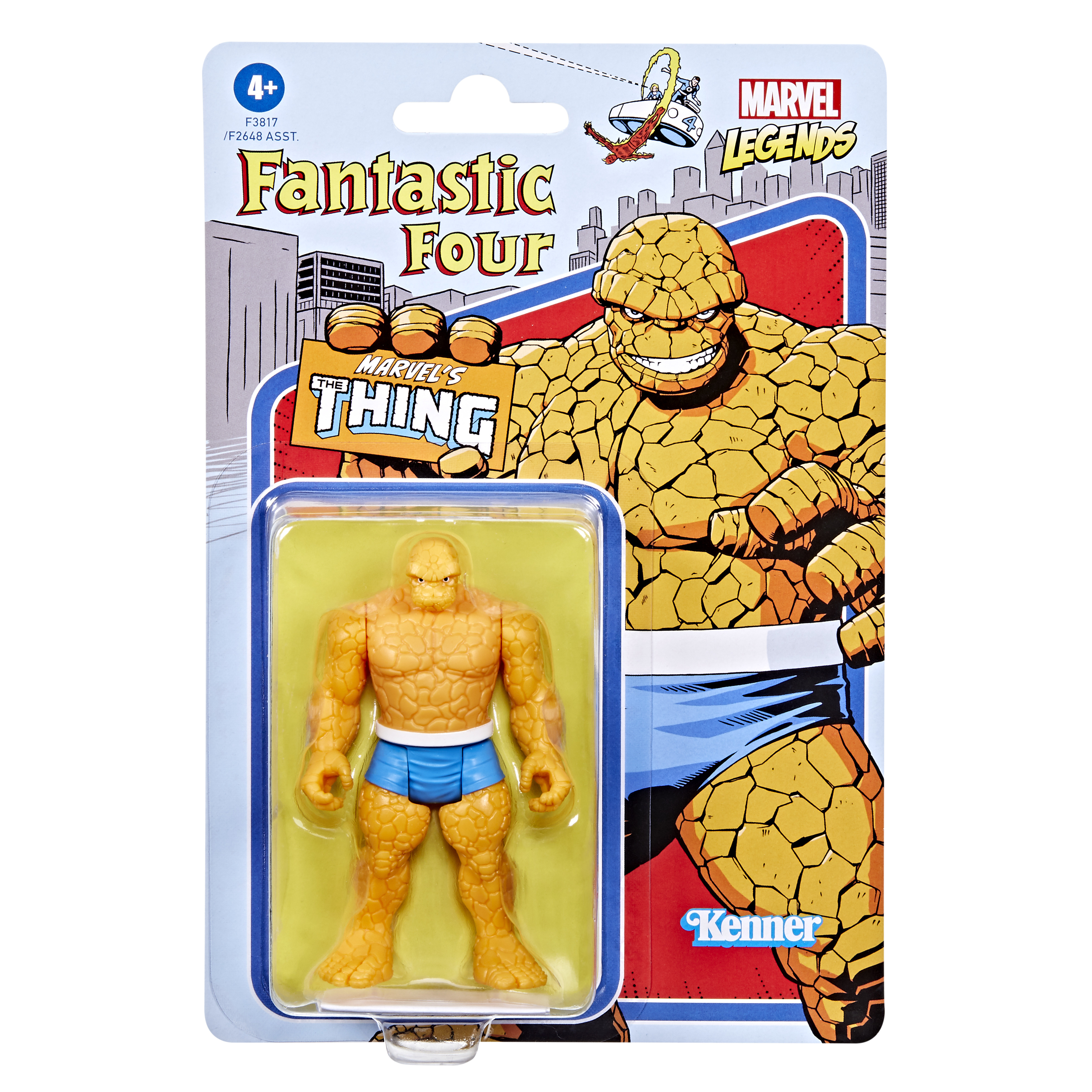 Action figure di The Thing nella confezione. Corpo arancione simile a roccia, pantaloncini blu. Sfondo con fumetti.