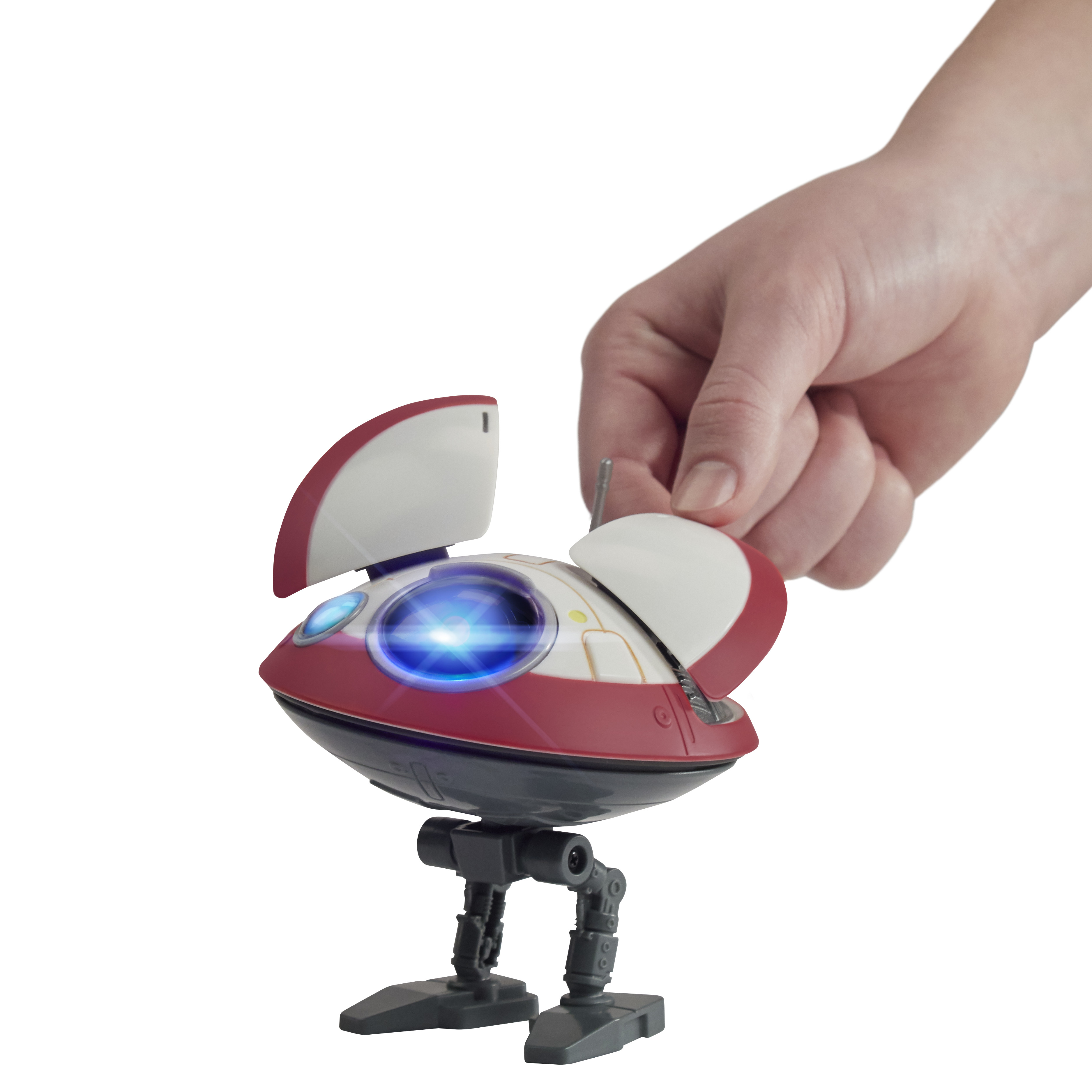 Robot giocattolo con una mano sopra. Il robot è rosso e bianco e ha una luce blu.