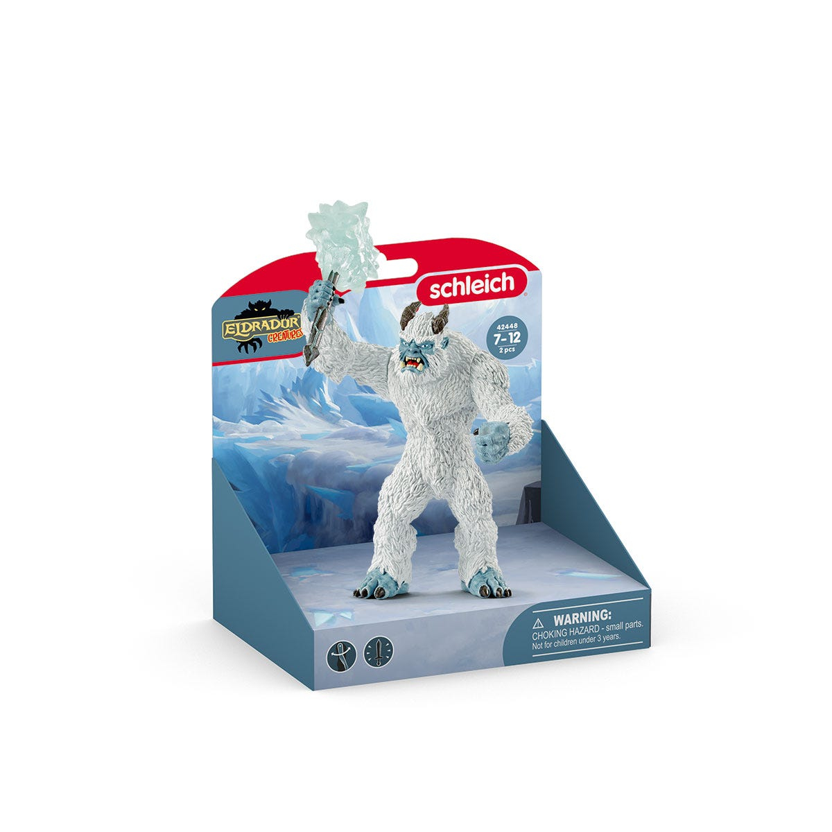 Un giocattolo Yeti in una scatola espositiva, con un'arma di ghiaccio, con uno sfondo innevato.