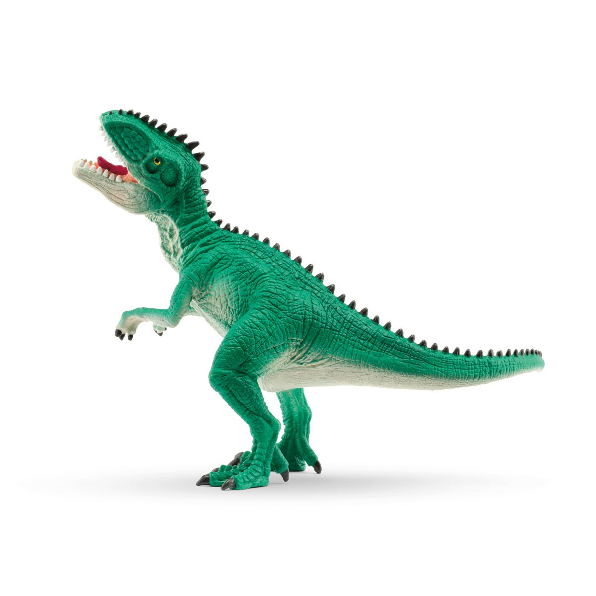 Un giocattolo di dinosauro verde con la bocca aperta, in piedi su una superficie bianca.