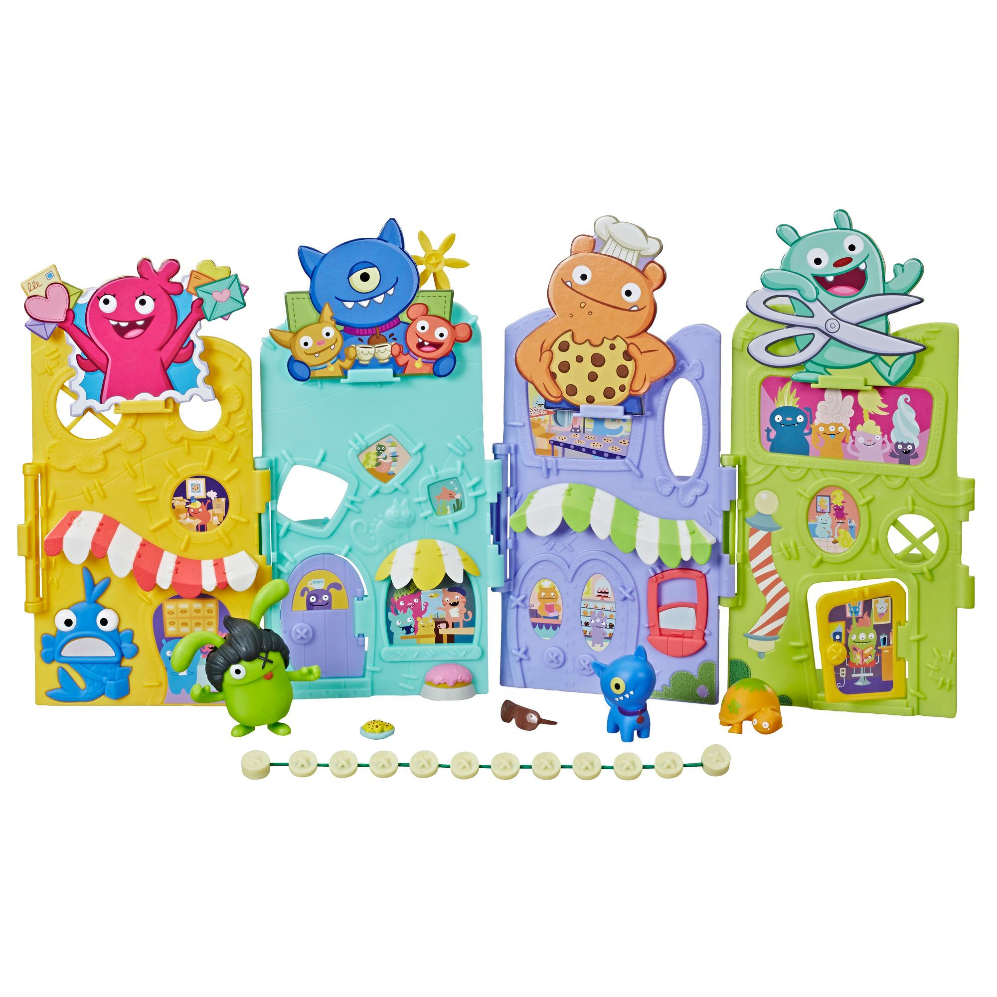 Un playset a tema mostri colorato con più edifici e varie figure di mostri e accessori.