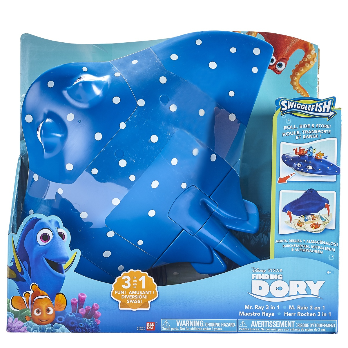 Manta giocattolo blu con pois bianchi nella scatola. Dory e Nemo sono sulla scatola. La scatola dei giocattoli dice Swigglefish e Alla ricerca di Dory.
