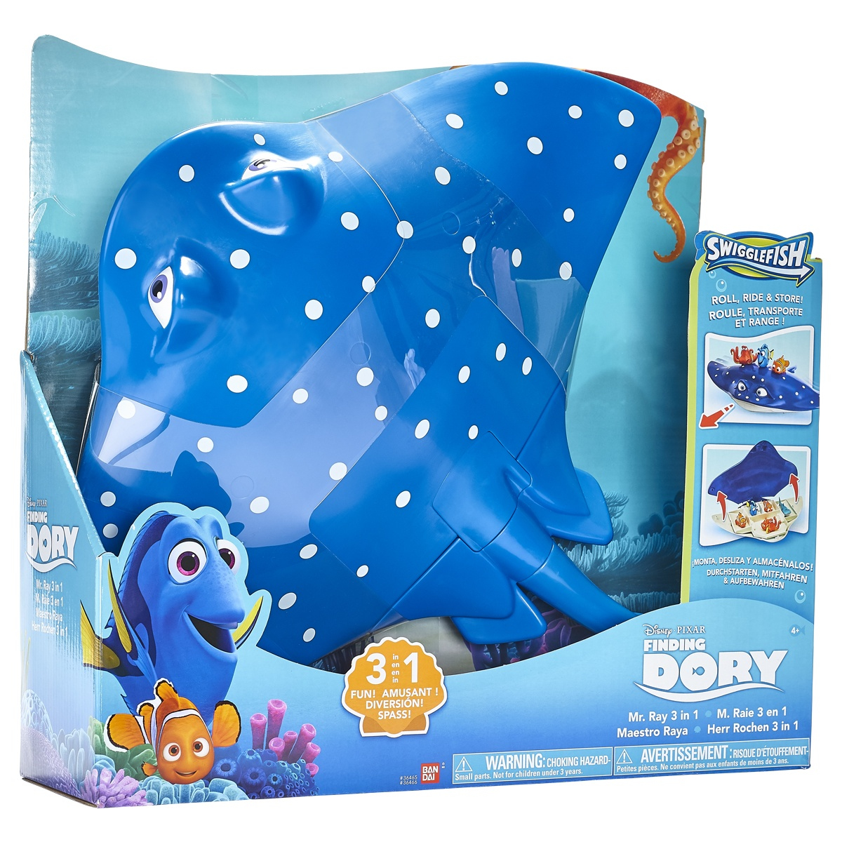 Giocattolo di Mr. Ray in una scatola, la scatola mostra Dory e Nemo. Il giocattolo è blu e bianco.