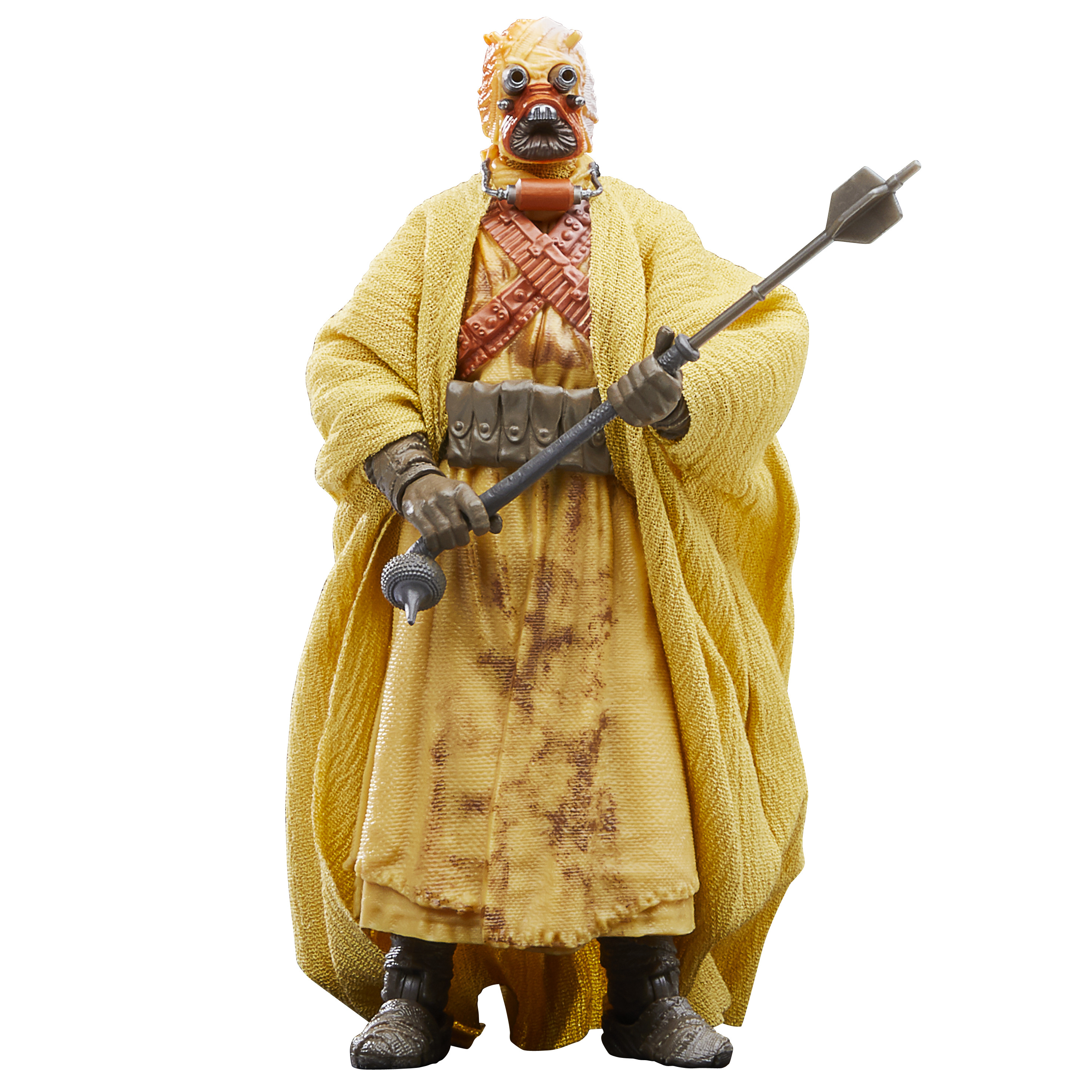 Un'action figure di Star Wars di un Tusken Raider con abiti gialli, che tiene un bastone.