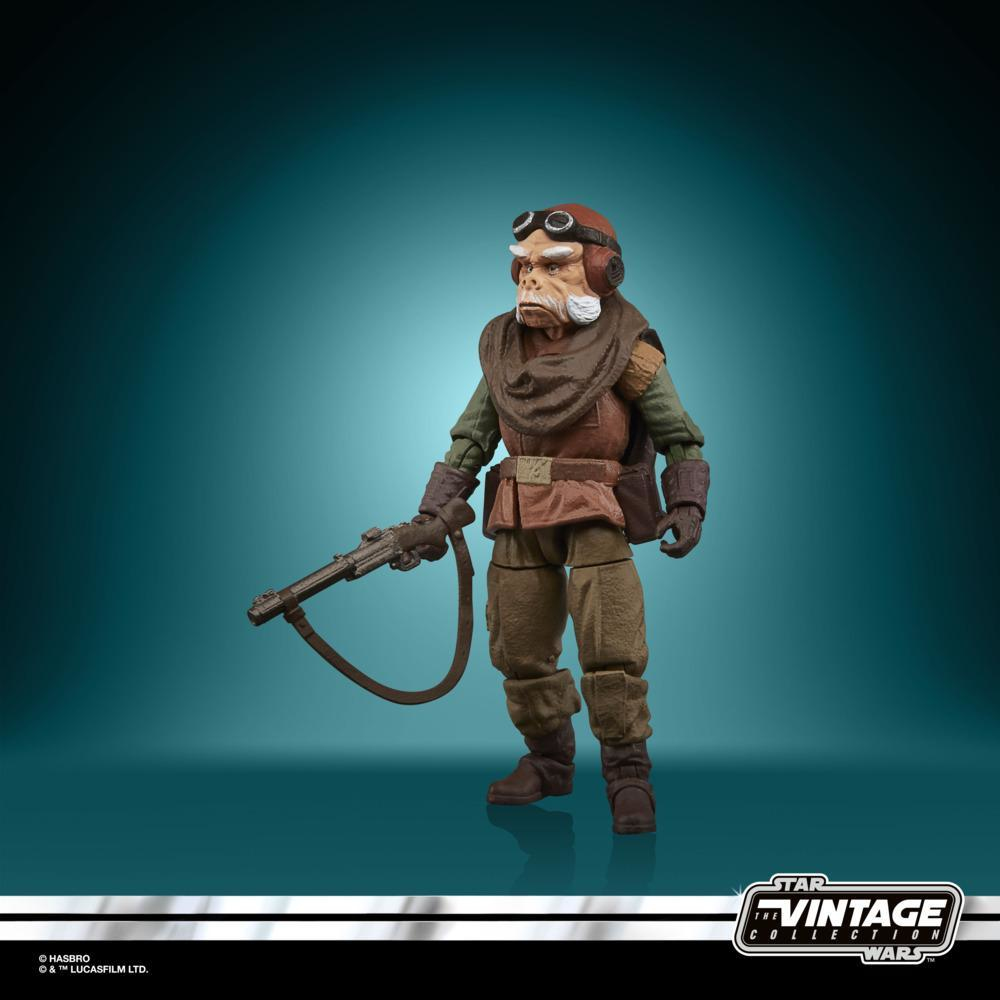 Una figura di Star Wars con occhiali e un'arma, in posa su uno sfondo verde acqua.