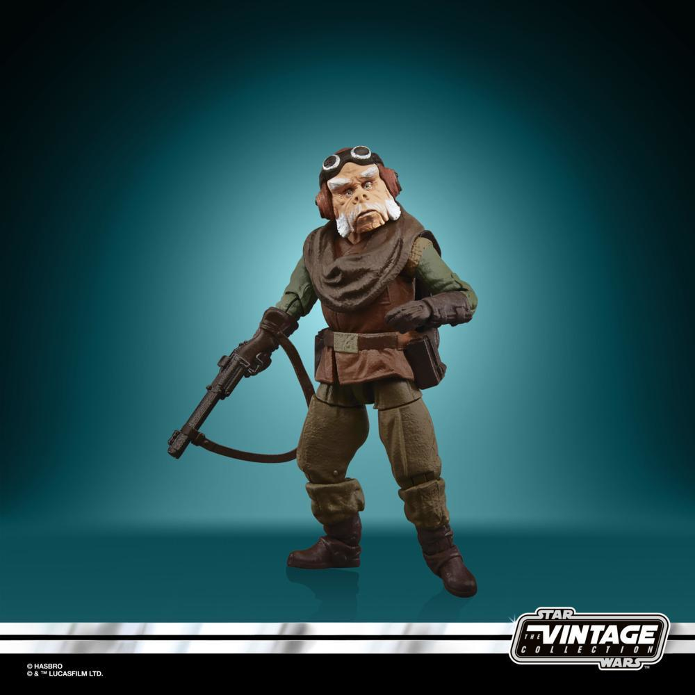 Una figura di Star Wars con occhiali e un'arma, in piedi di fronte a uno sfondo verde acqua.