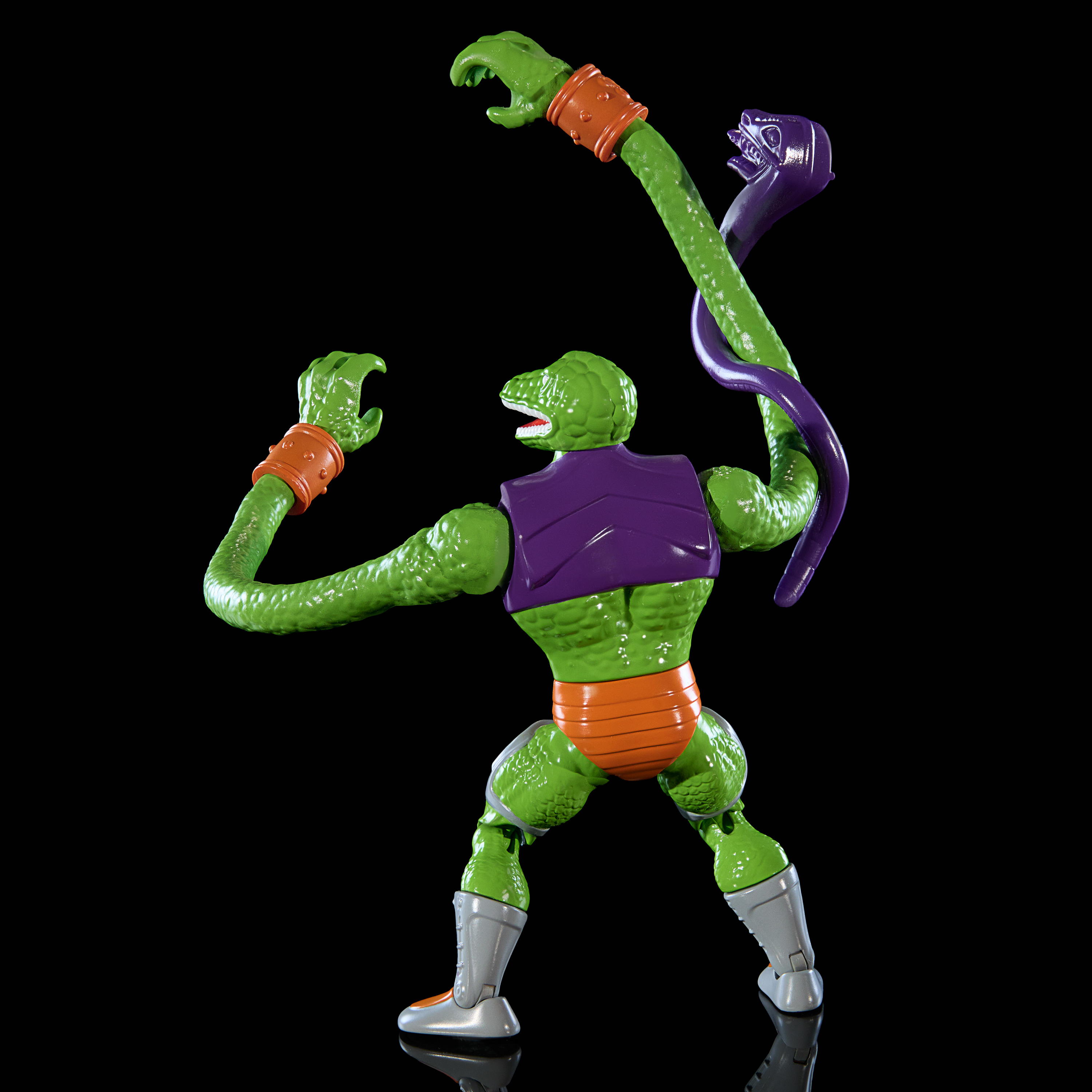 Actionfigur einer grünen, echsenartigen Kreatur mit orangefarbenen Armbändern und einer lila Weste.