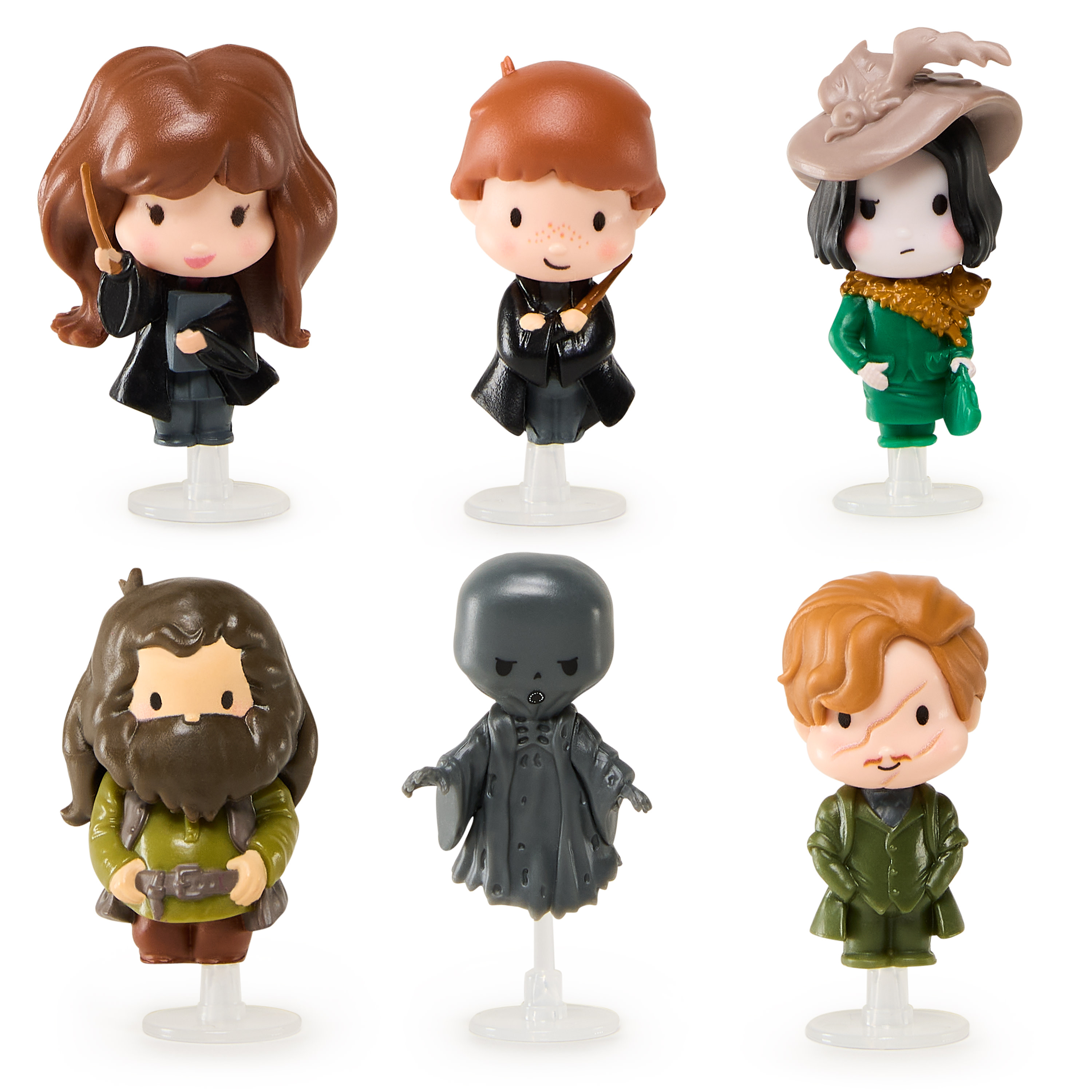 Seis figuras en miniatura de Harry Potter sobre soportes transparentes. Los personajes incluyen a Harry, Ron, Snape y otros.
