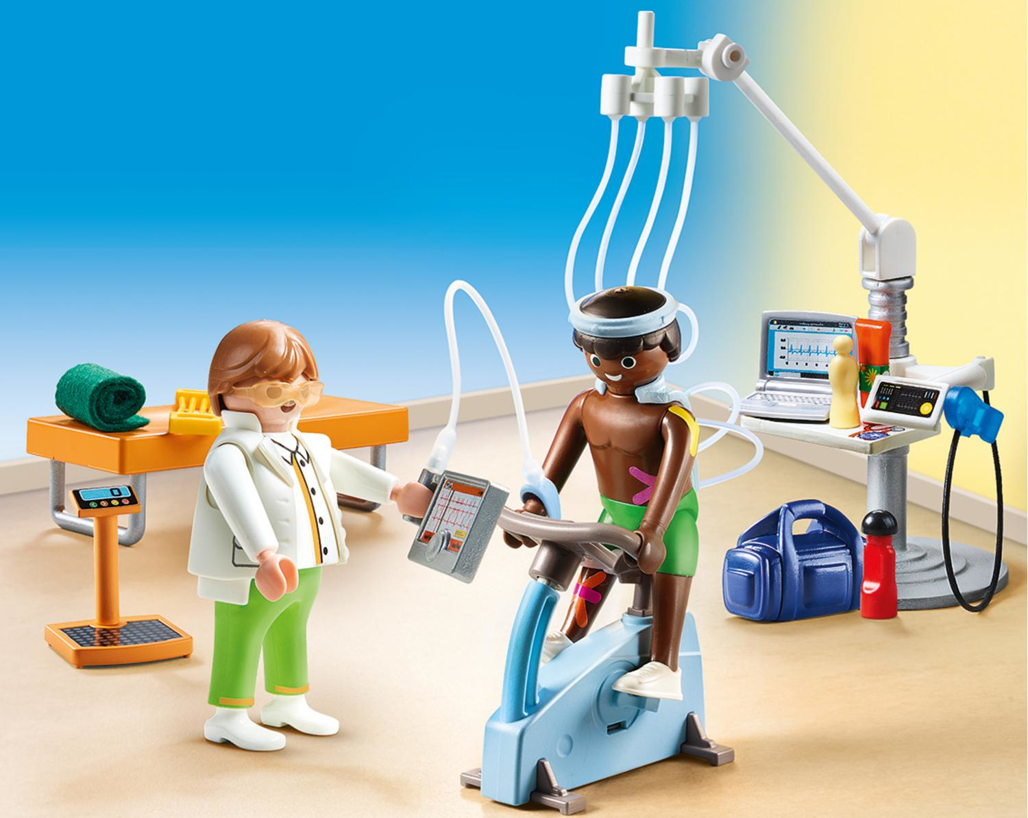 Scena Playmobil: lekarz z pacjentem na rowerze stacjonarnym, podłączonym do sprzętu medycznego.