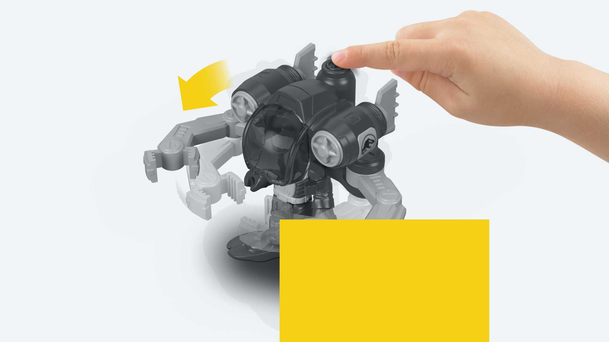 Ręka dziecka naciska na górę czarnej zabawki robota. Robot ma ramiona i przezroczystą kopułę.