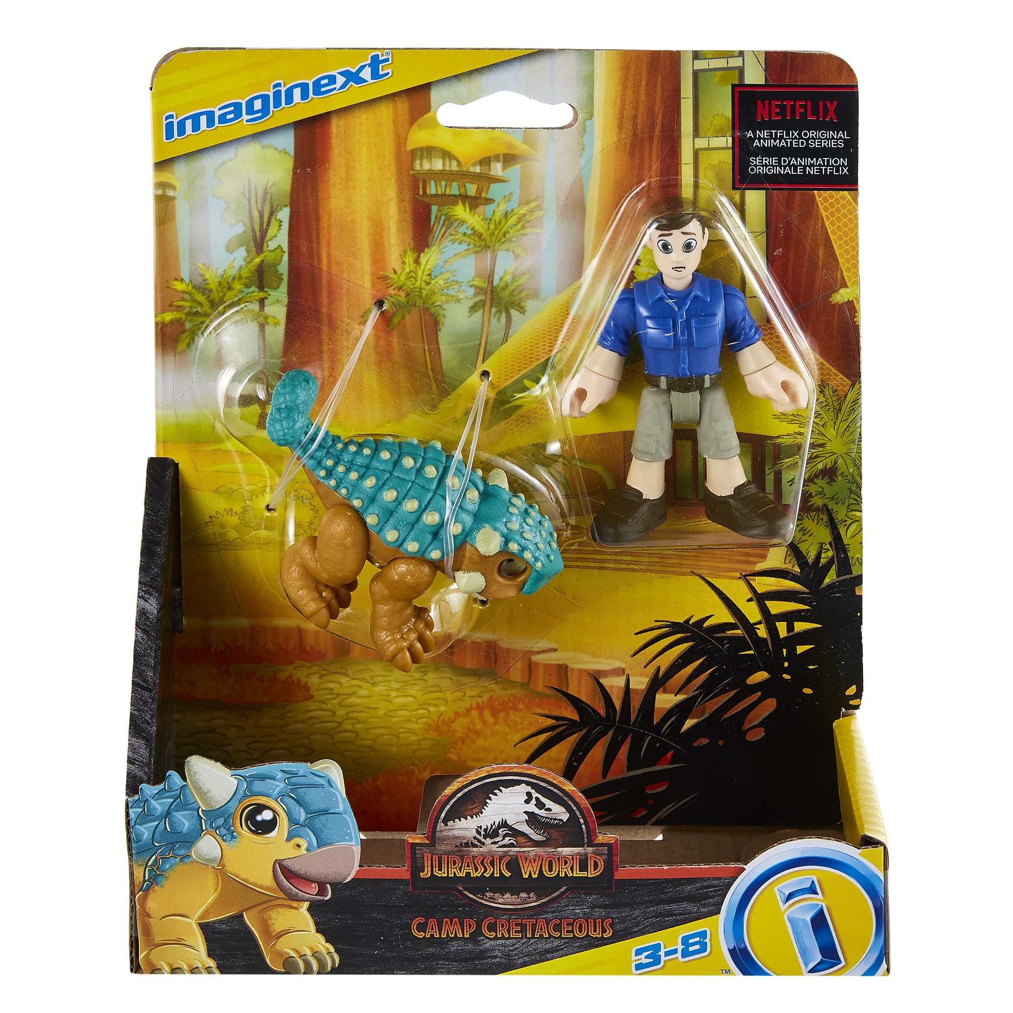 Zabawka Imaginext w pudełku. Dinozaur i mężczyzna w niebieskiej koszuli są w opakowaniu. Tło: drzewa.