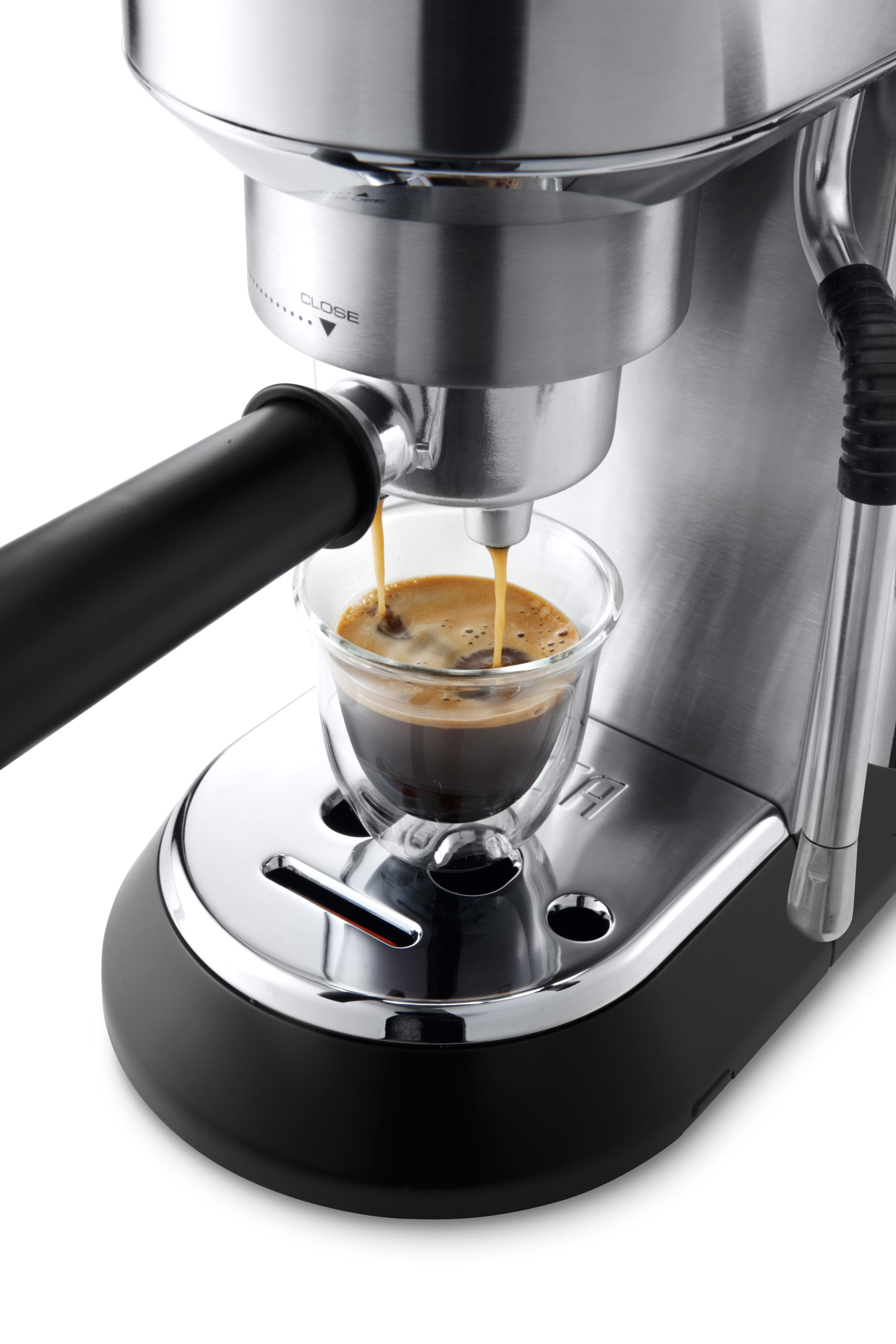 Espressomaschine, die Kaffee in ein Glas brüht. Die Maschine ist silber und schwarz.