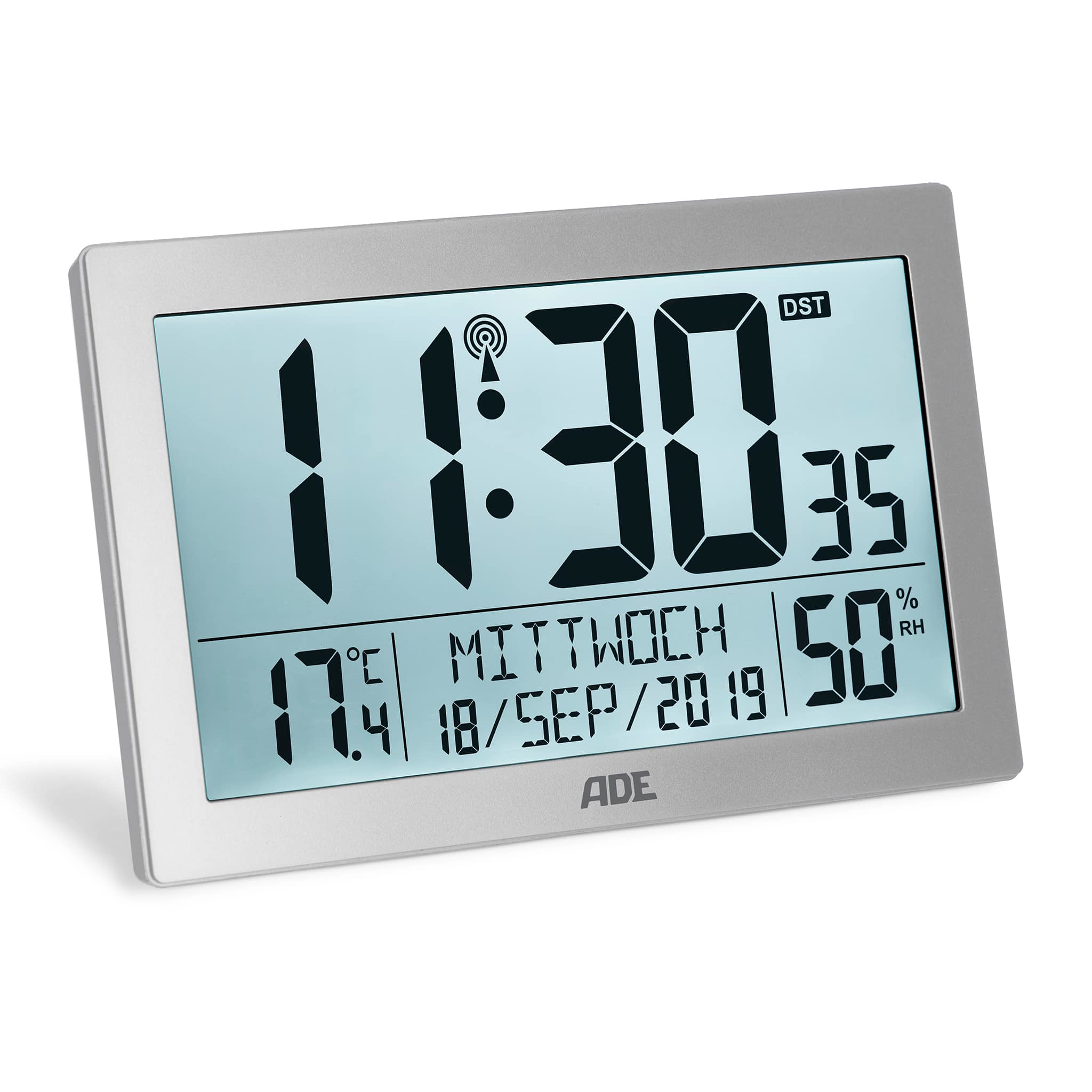 Digitaluhr, silberner Rahmen, 11:30 Uhr, Temperatur und Datum. Weißer Hintergrund.