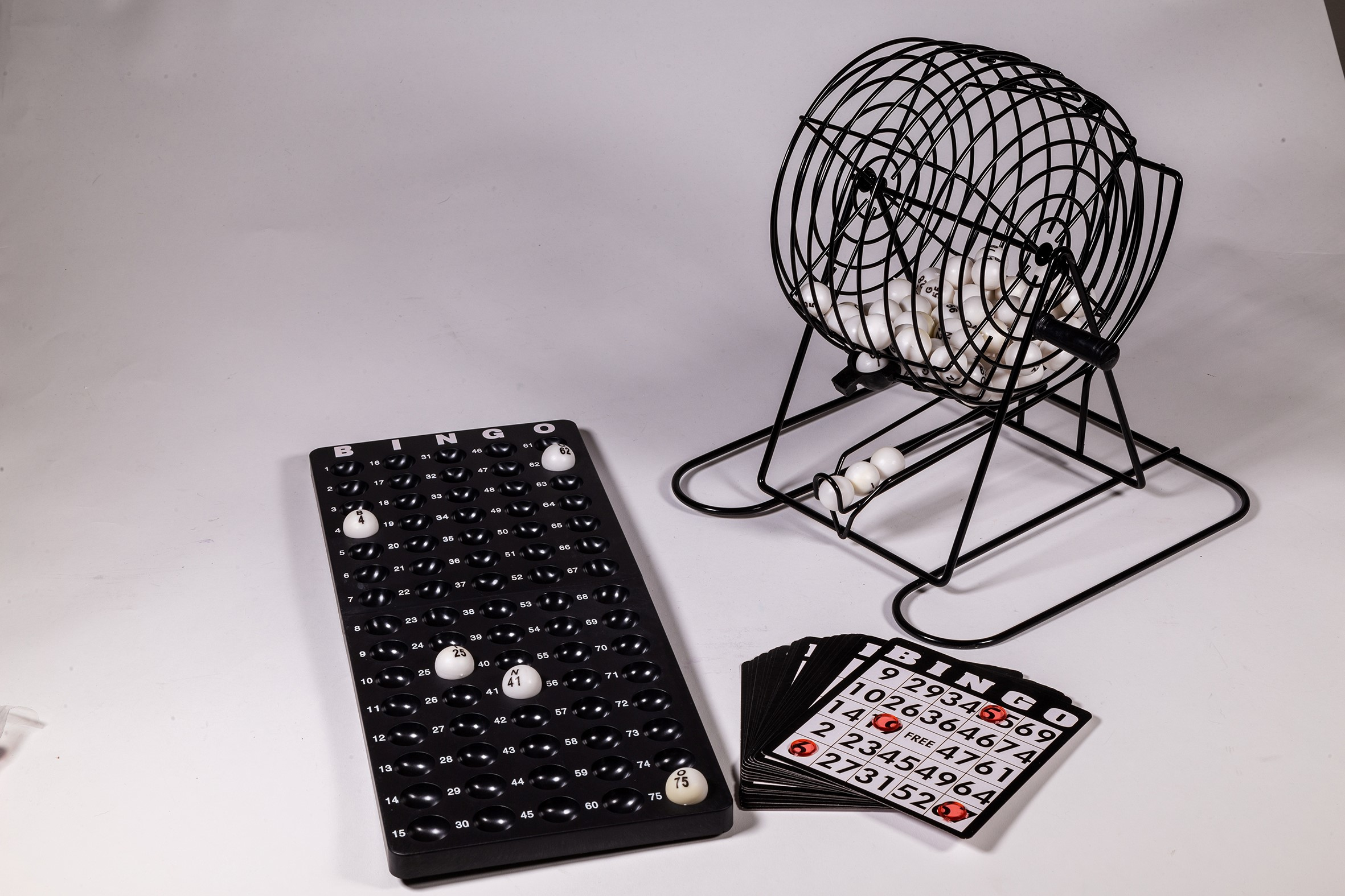 Un set di bingo con gabbia, tabellone e carte.