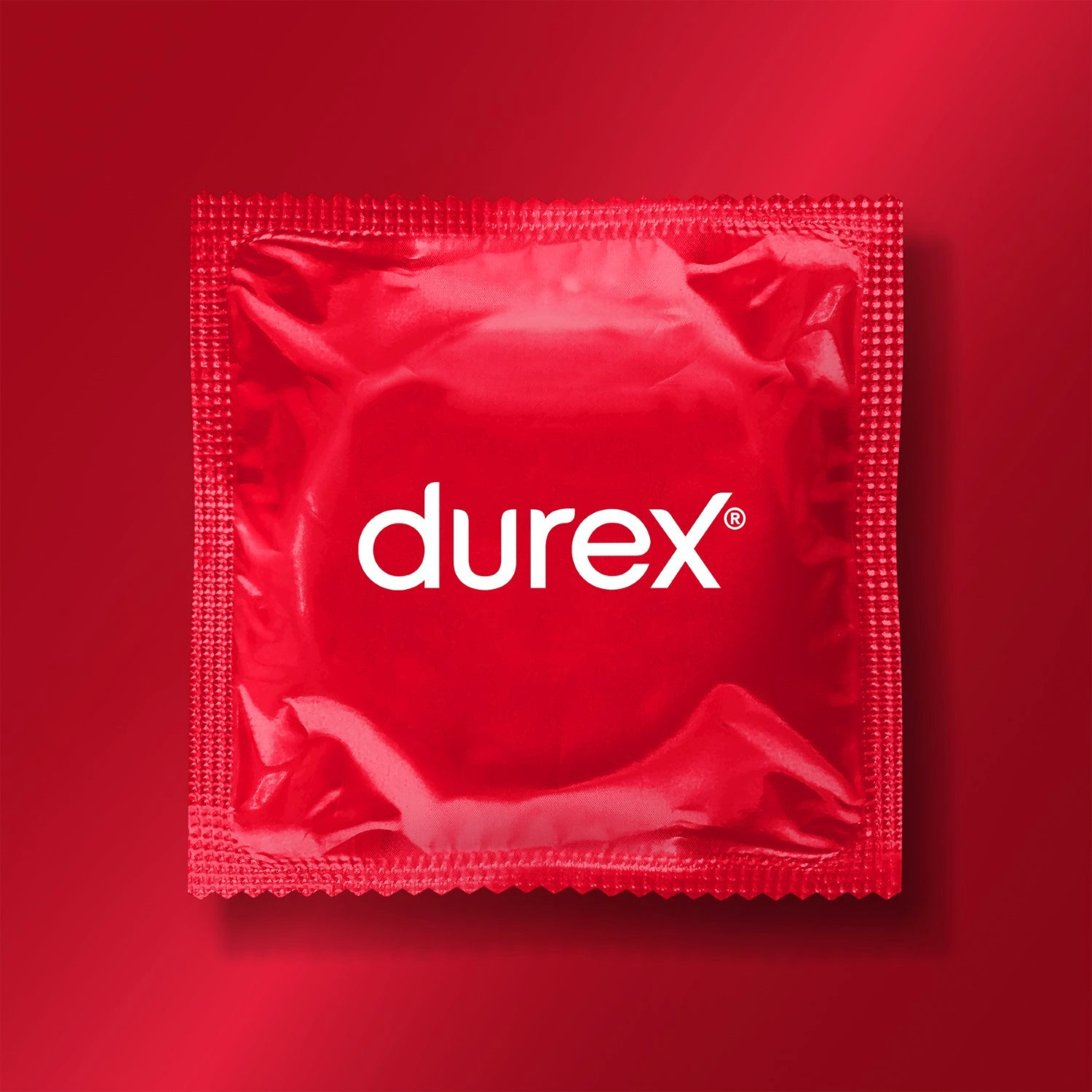 Rote Durex Kondomverpackung. Das Wort 'durex' steht weiß auf der Vorderseite.