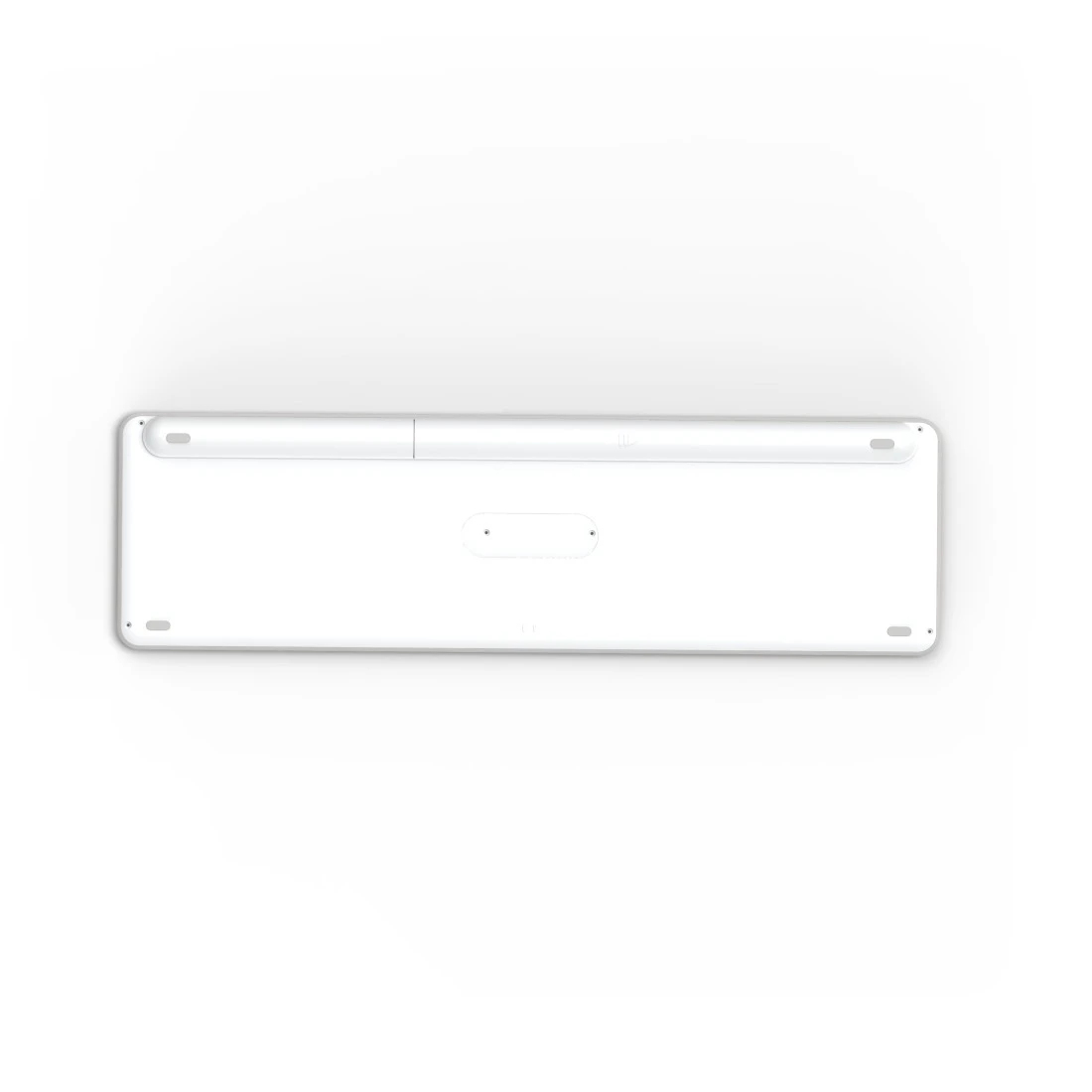 La parte trasera de un teclado blanco con marco de color claro. Muestra algunas hendiduras circulares.