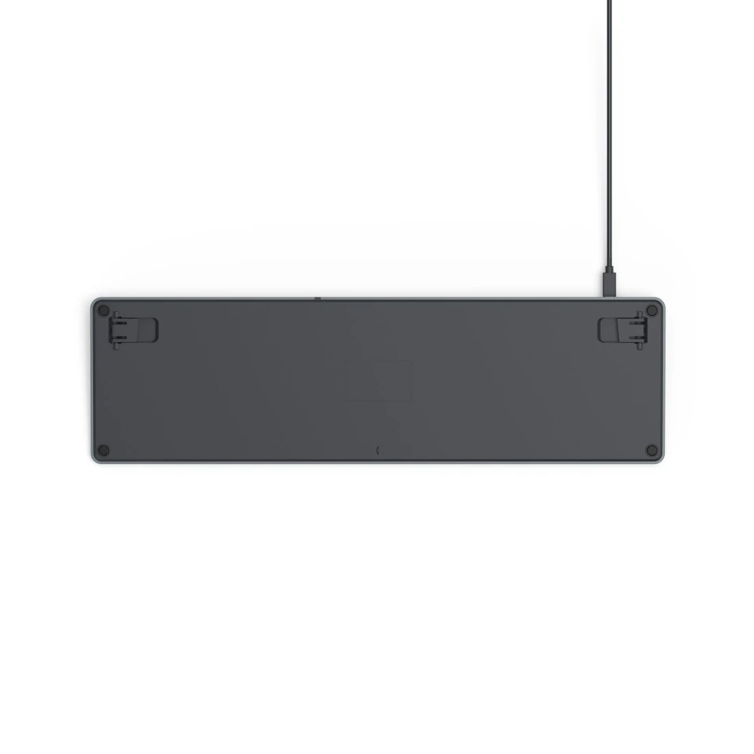 Widok od spodu ciemnoszarej klawiatury, z kablem oraz widocznymi śrubami i punktami montażowymi.