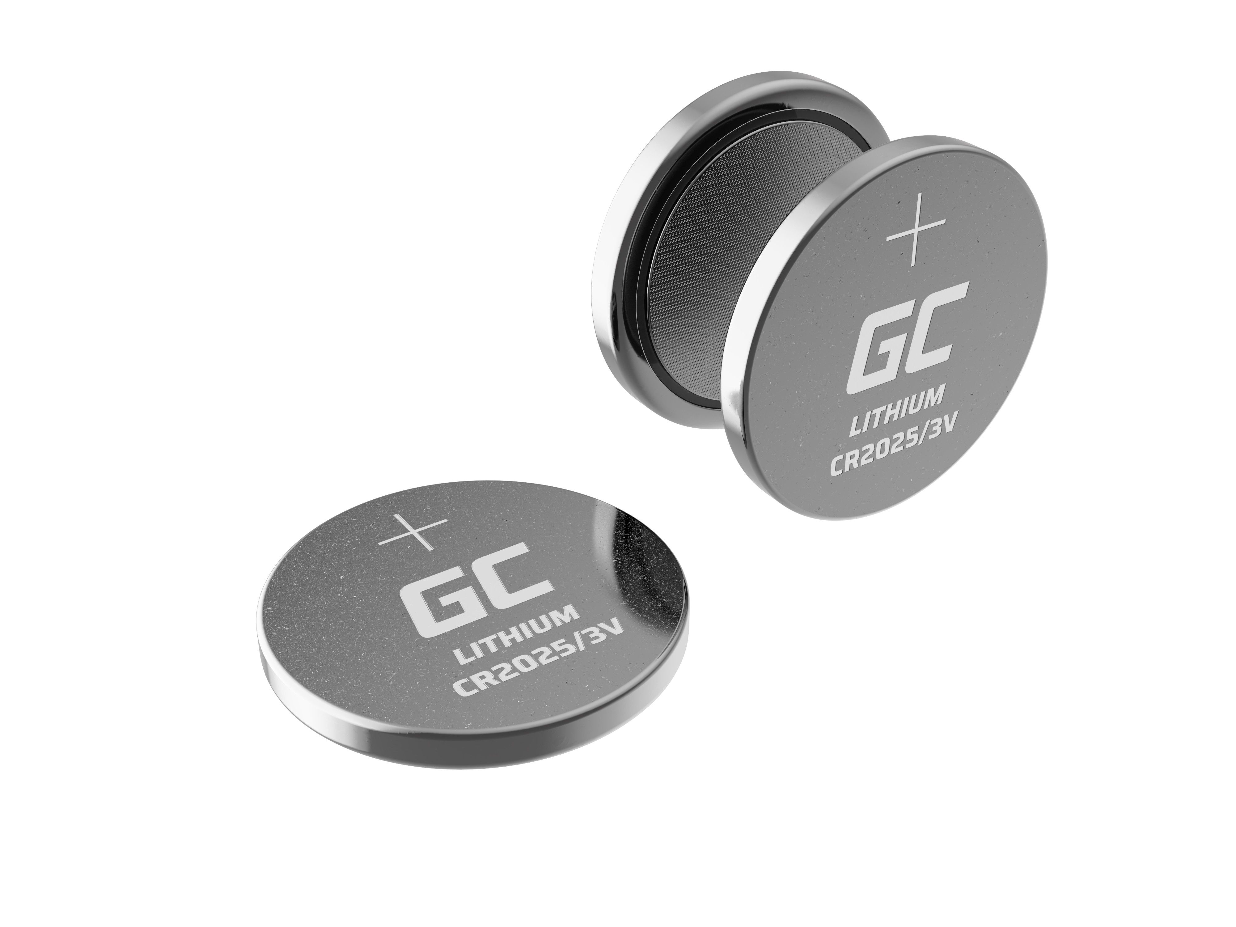 Dwie srebrne baterie pastylkowe. Jedna otwarta, druga zamknięta. Białe tło.