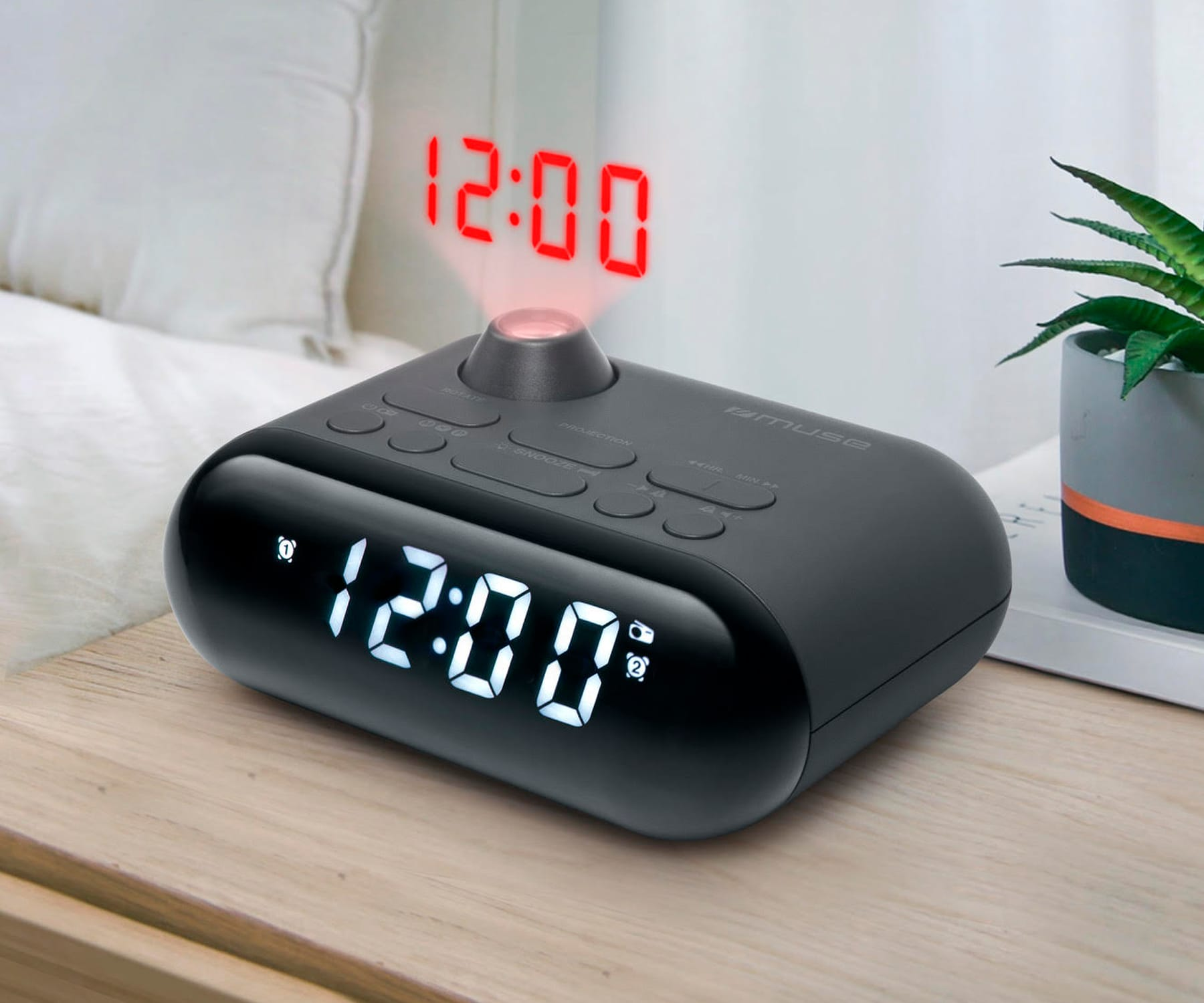 Czarny cyfrowy budzik wyświetlający godzinę 12:00 na czerwono. Pokazuje 12:00 na wyświetlaczu.