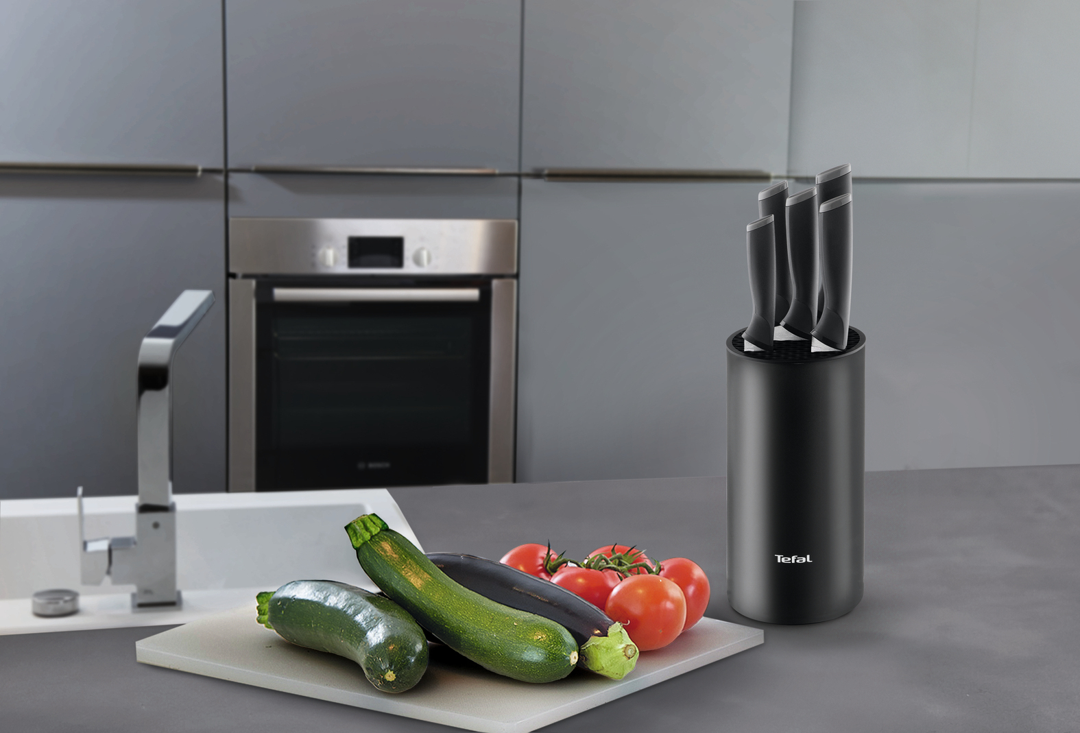 Noże w czarnym stojaku, warzywa i deska do krojenia w nowoczesnej kuchni.