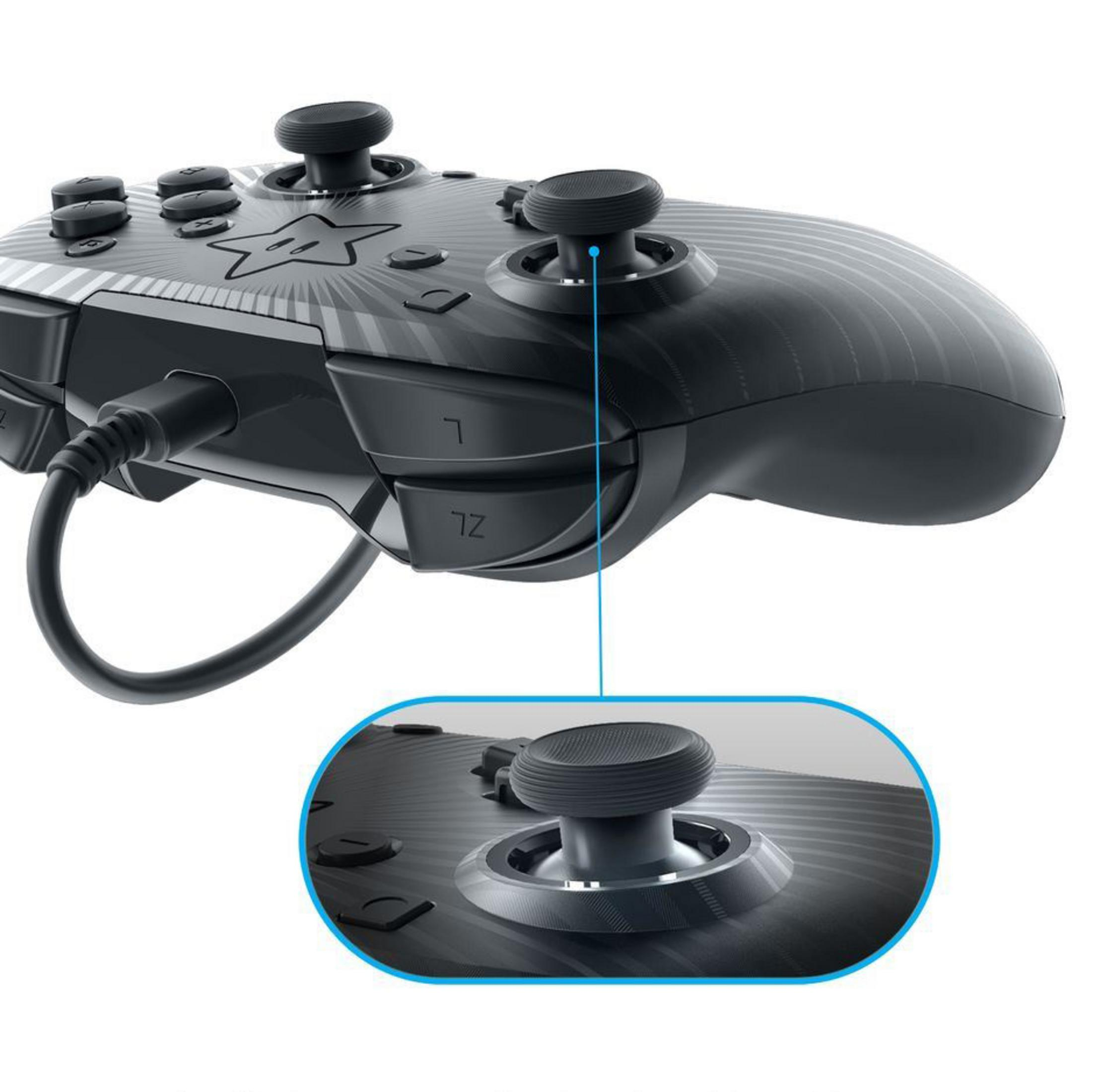Czarny kontroler z wzorem rozbłysku gwiazdy. Zbliżenie na joystick.