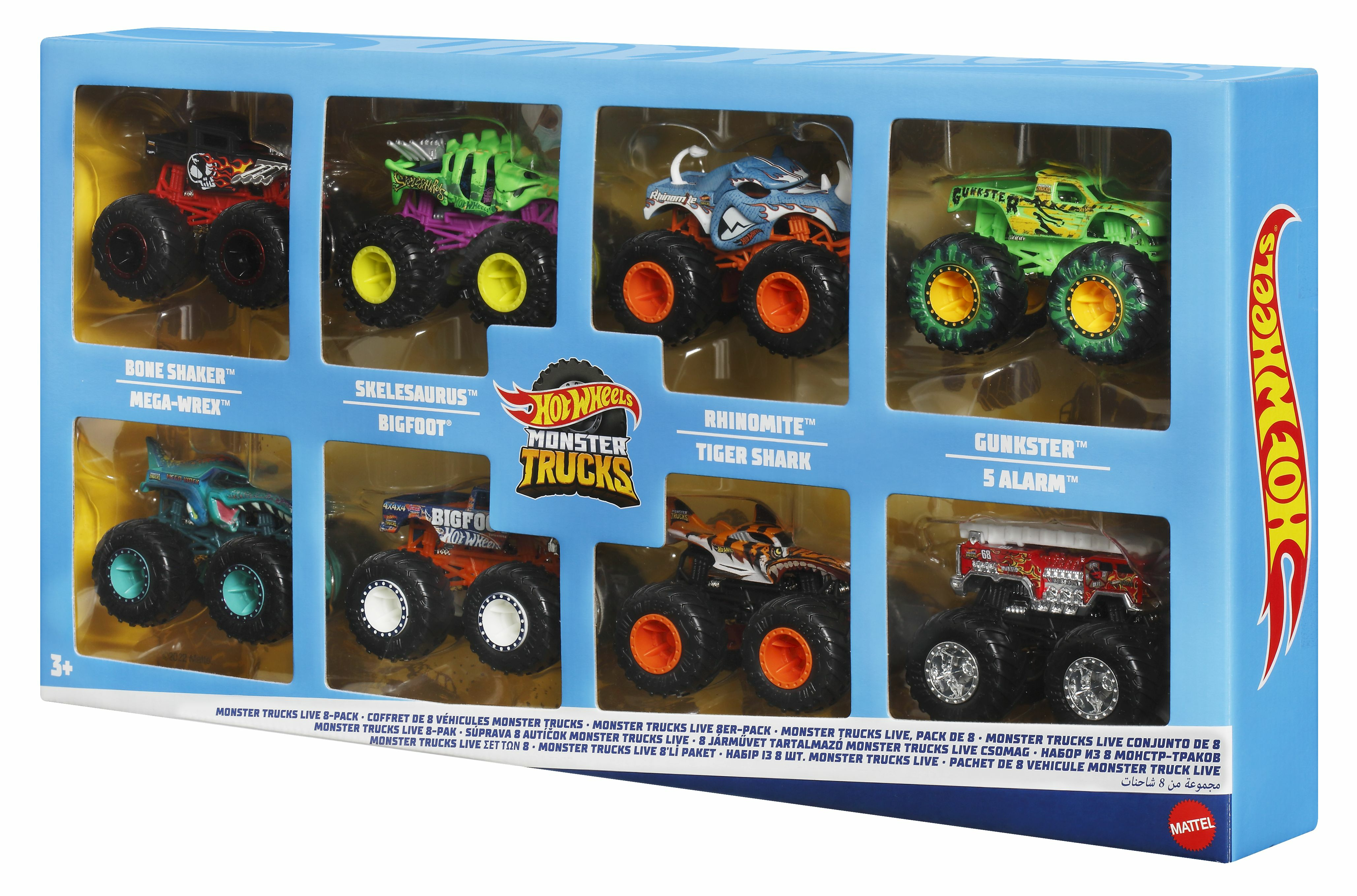 Acht Hot Wheels Monstertrucks in einer blauen Box. Trucks sind in verschiedenen Farben und Stilen.