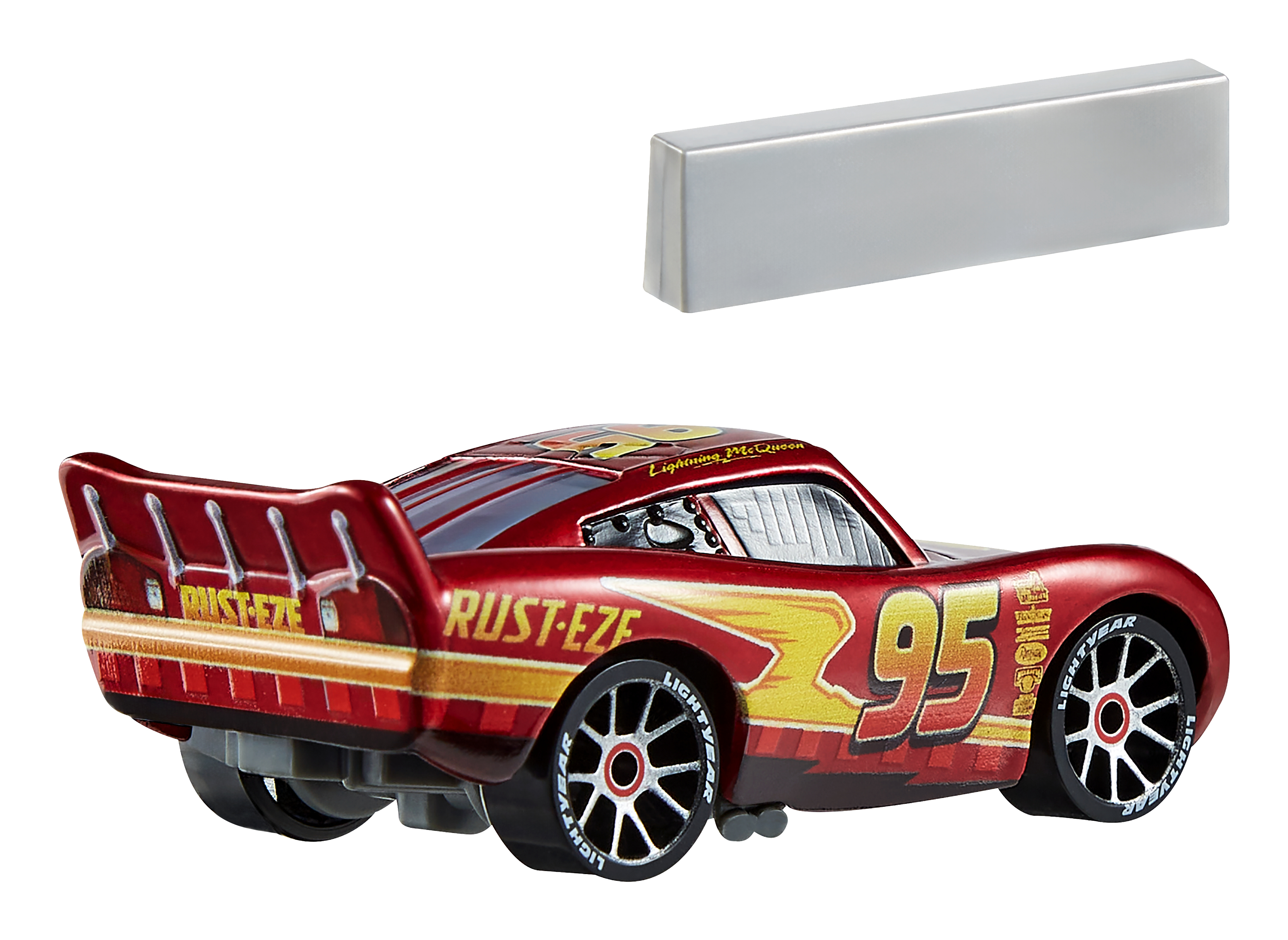 Coche rojo Lightning McQueen con el número 95, una señal plateada está encima del coche.
