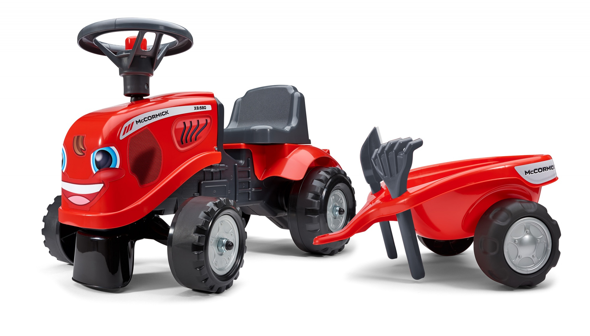 Tractor de juguete rojo con cara sonriente, tirando de un remolque rojo a juego.
