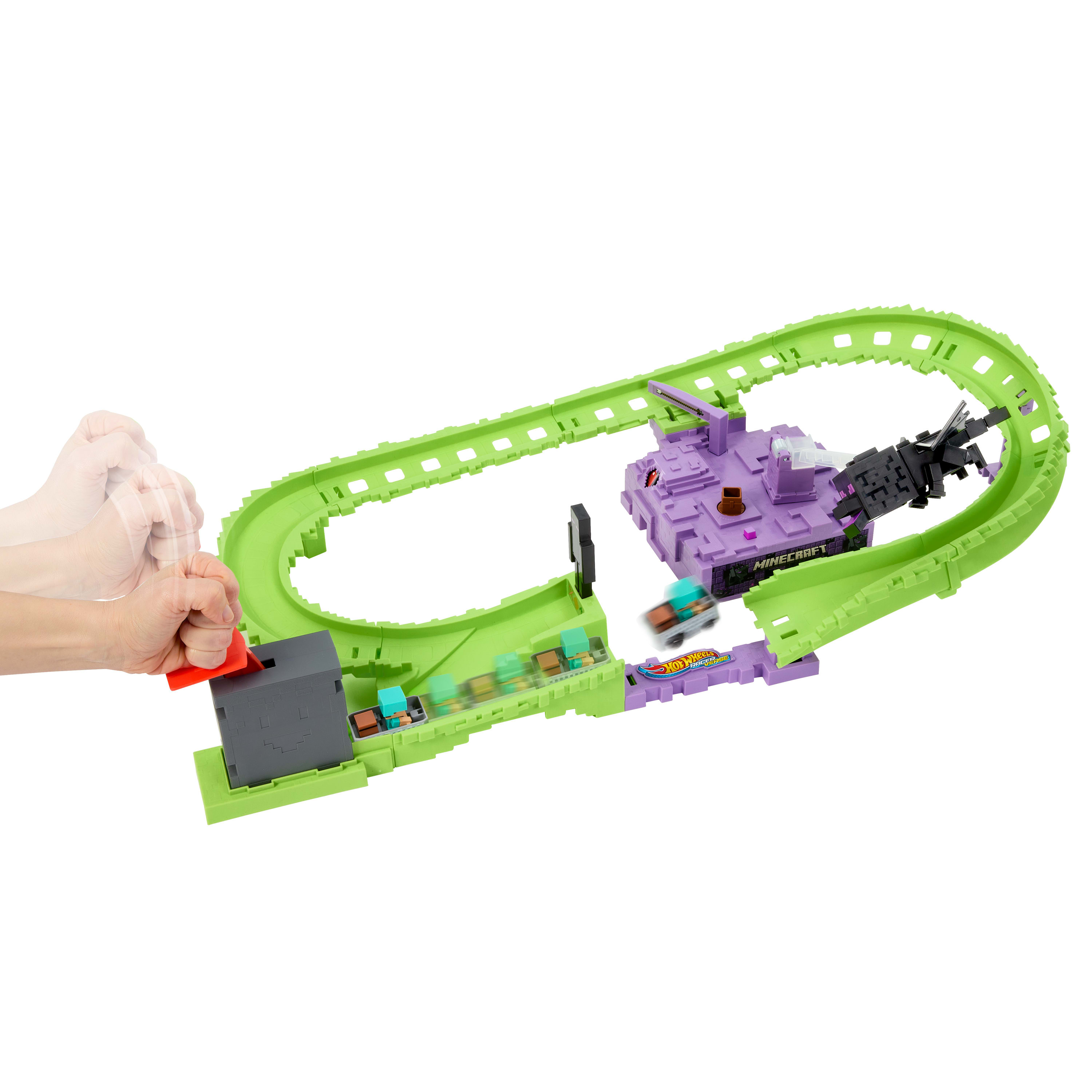 Una mano acciona una palanca en una pista verde con un juego de Minecraft y un coche pequeño corriendo por la pista.