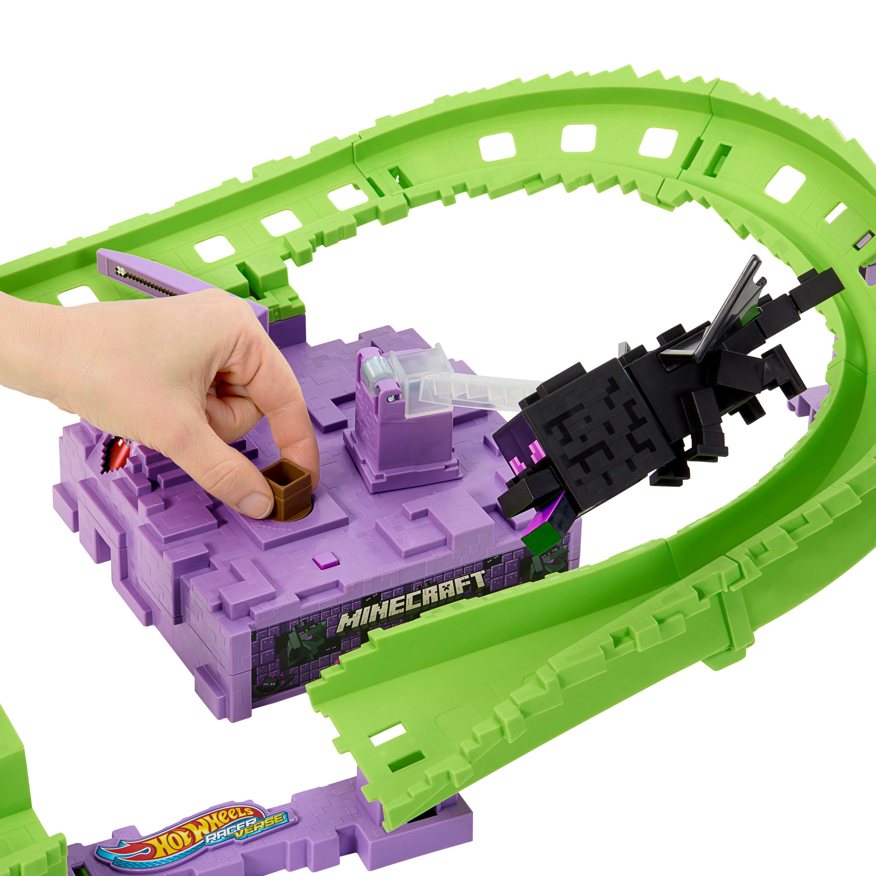 Una mano coloca un bloque marrón en un juego de Minecraft morado con una pista verde y una figura de dragón negro.