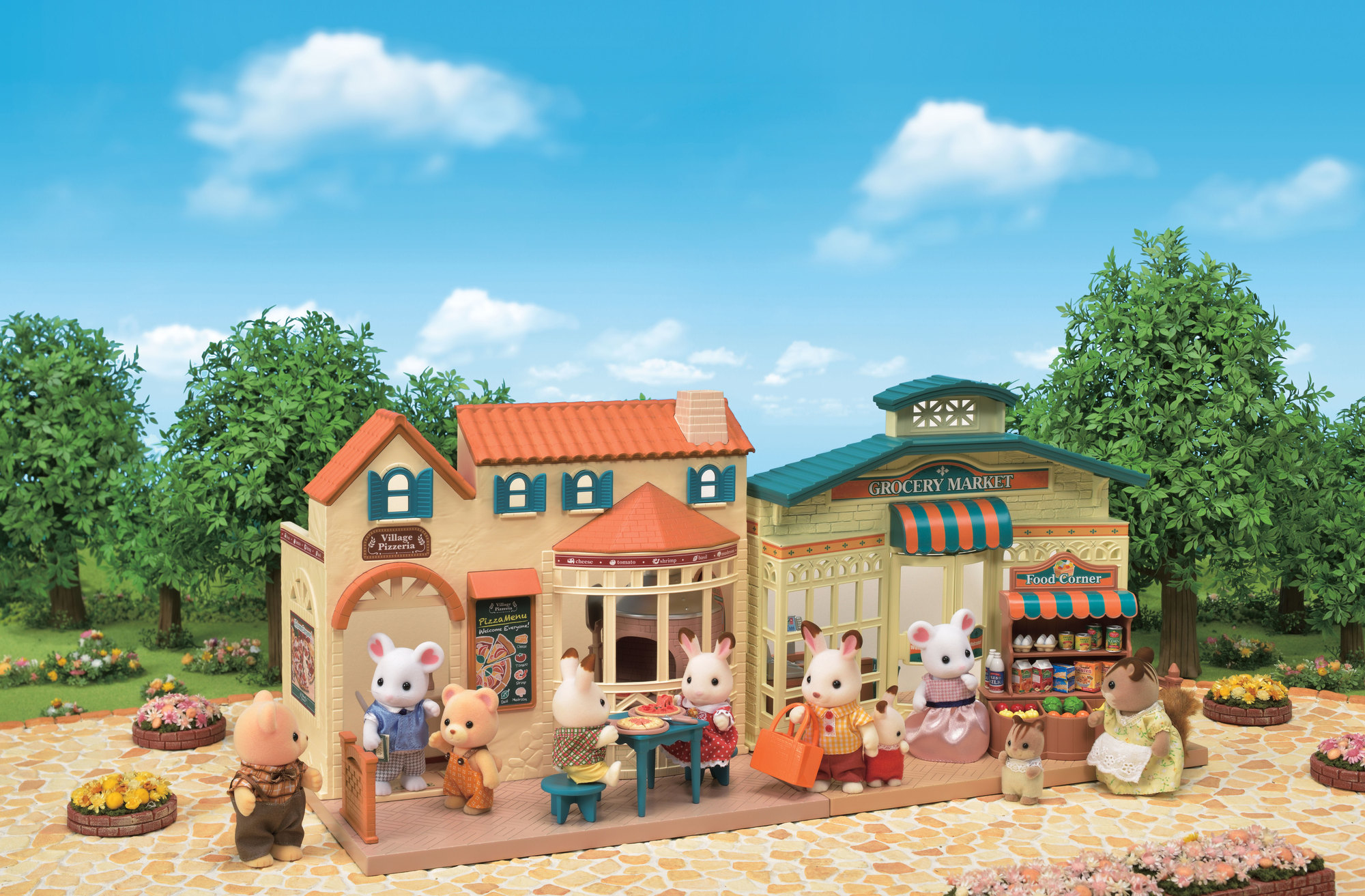 Zestaw do zabawy Sylvanian Families. Prezentuje ulicę ze sklepami, w tym pizzerię i sklep spożywczy.