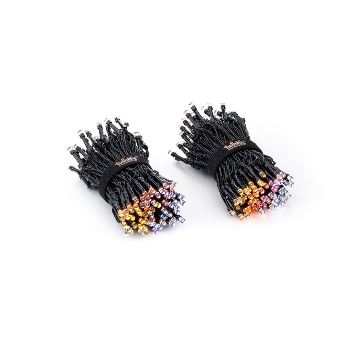 Dwa pęki lampek choinkowych z kolorowymi żarówkami, spięte czarnymi opaskami.