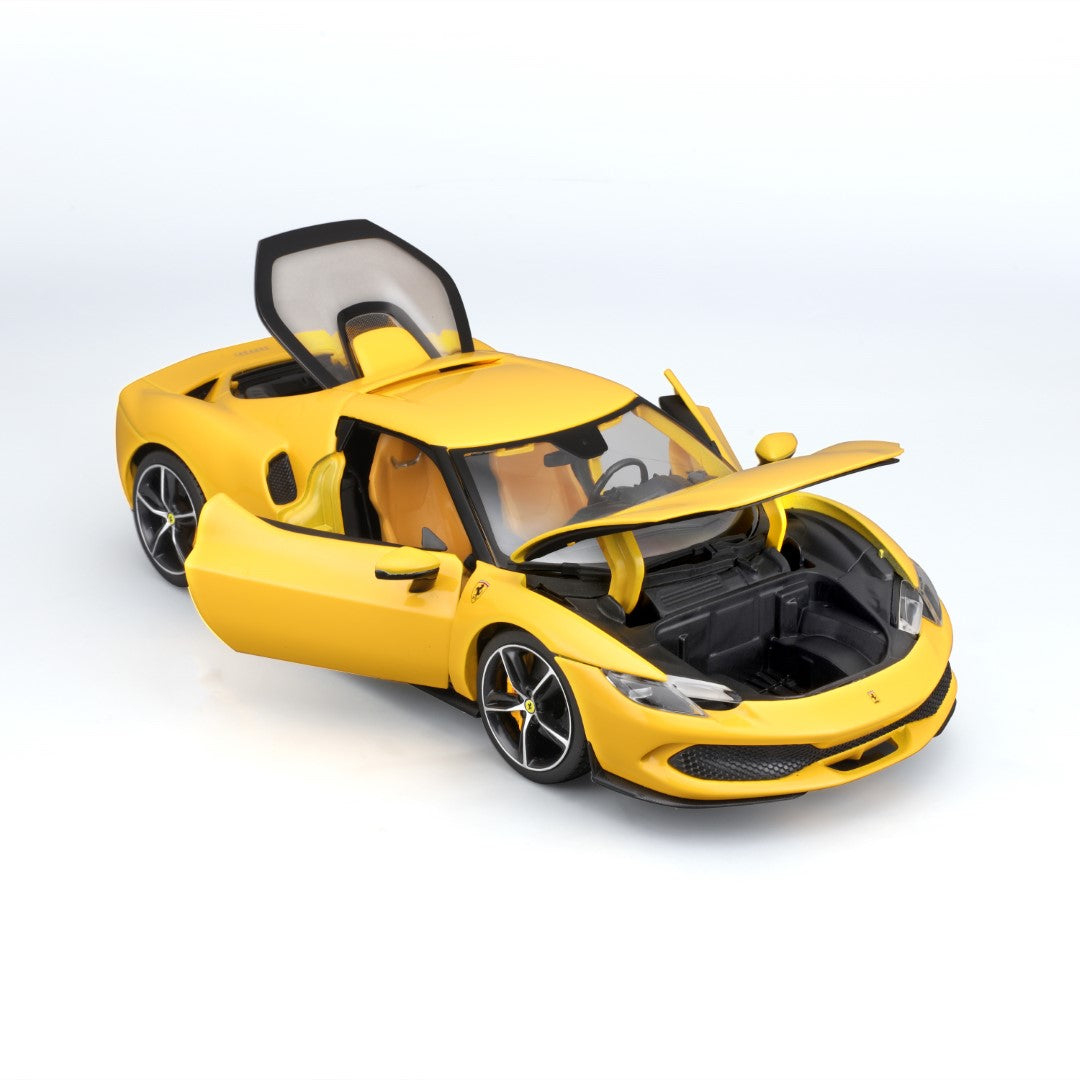 Żółty zabawkowy samochód Ferrari, otwarte drzwi i maska. Białe tło.